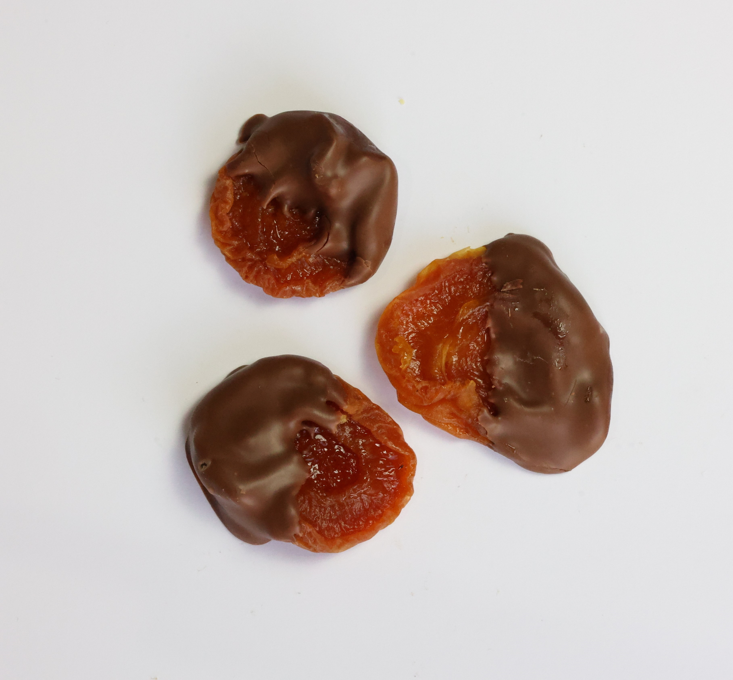 Dried apricots partially dipped in chocolate.