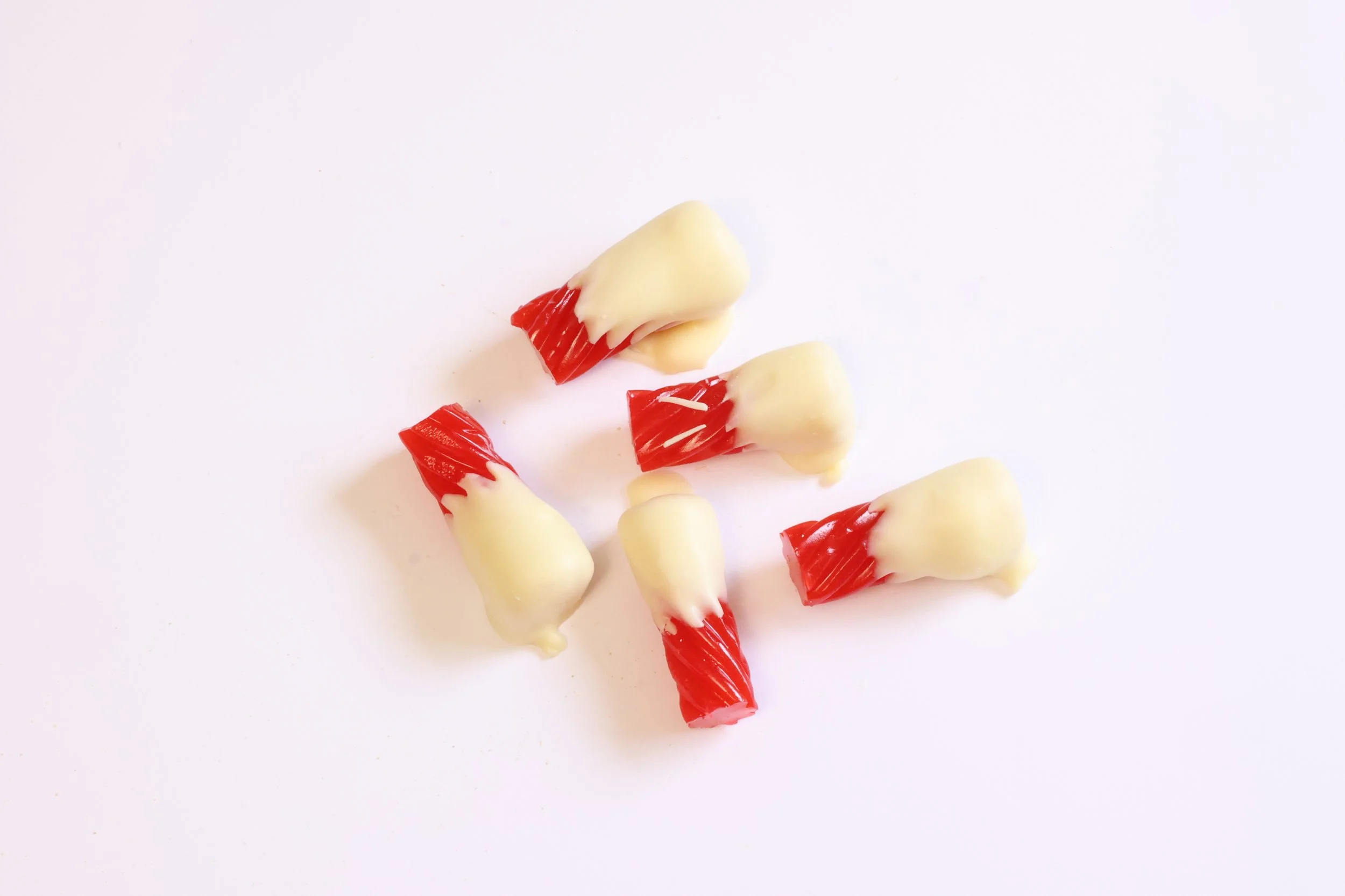 White chocolate dipped red licorice.