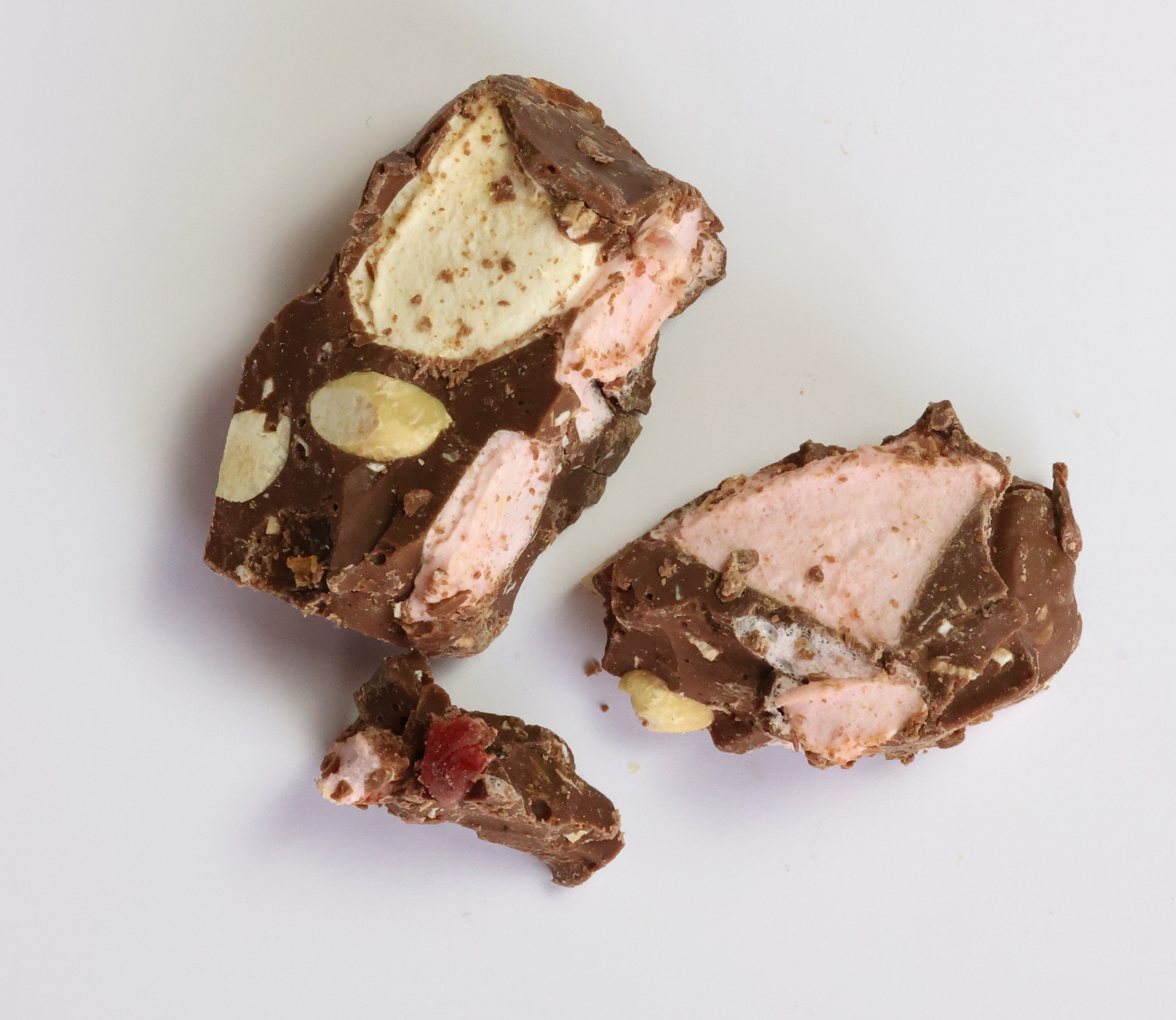 Chocolate-covered Rocky Road candy with marshmallows, nuts, and dried fruit.