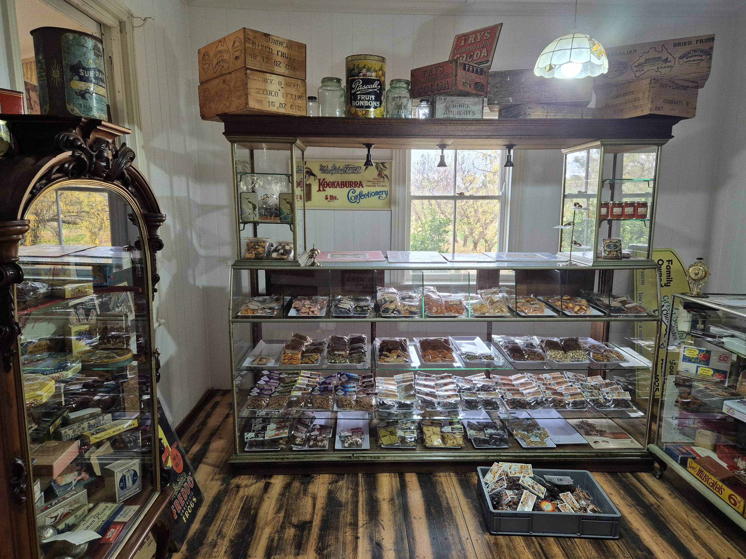 A vintage candy shop display case filled with various packaged candies and treats. Roy Farms / Great Southern Chocolates Renmark store front.