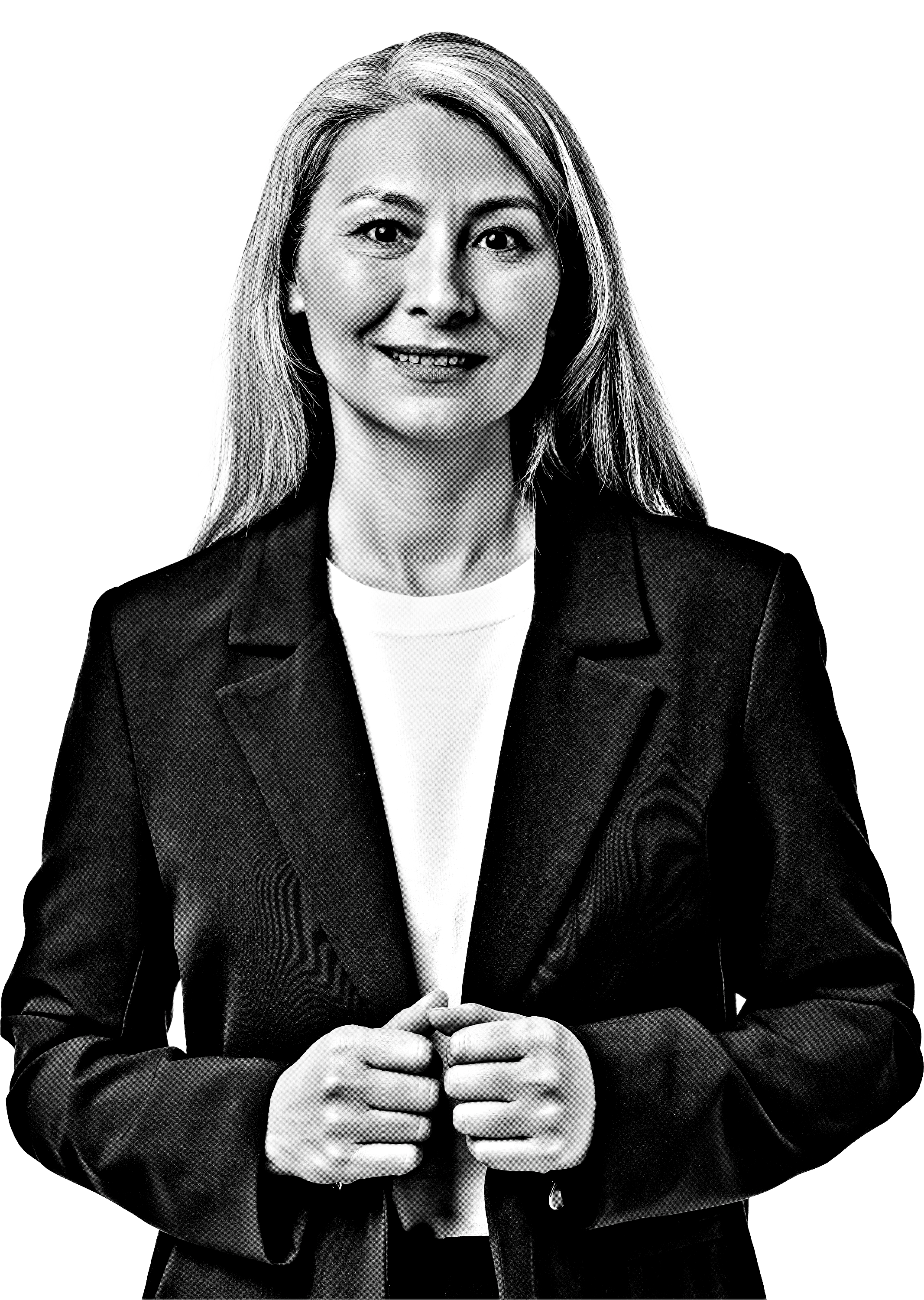 Black and white photo of a woman with shoulder-length hair, smiling and dressed in a blazer and white shirt, standing with her hands clasped