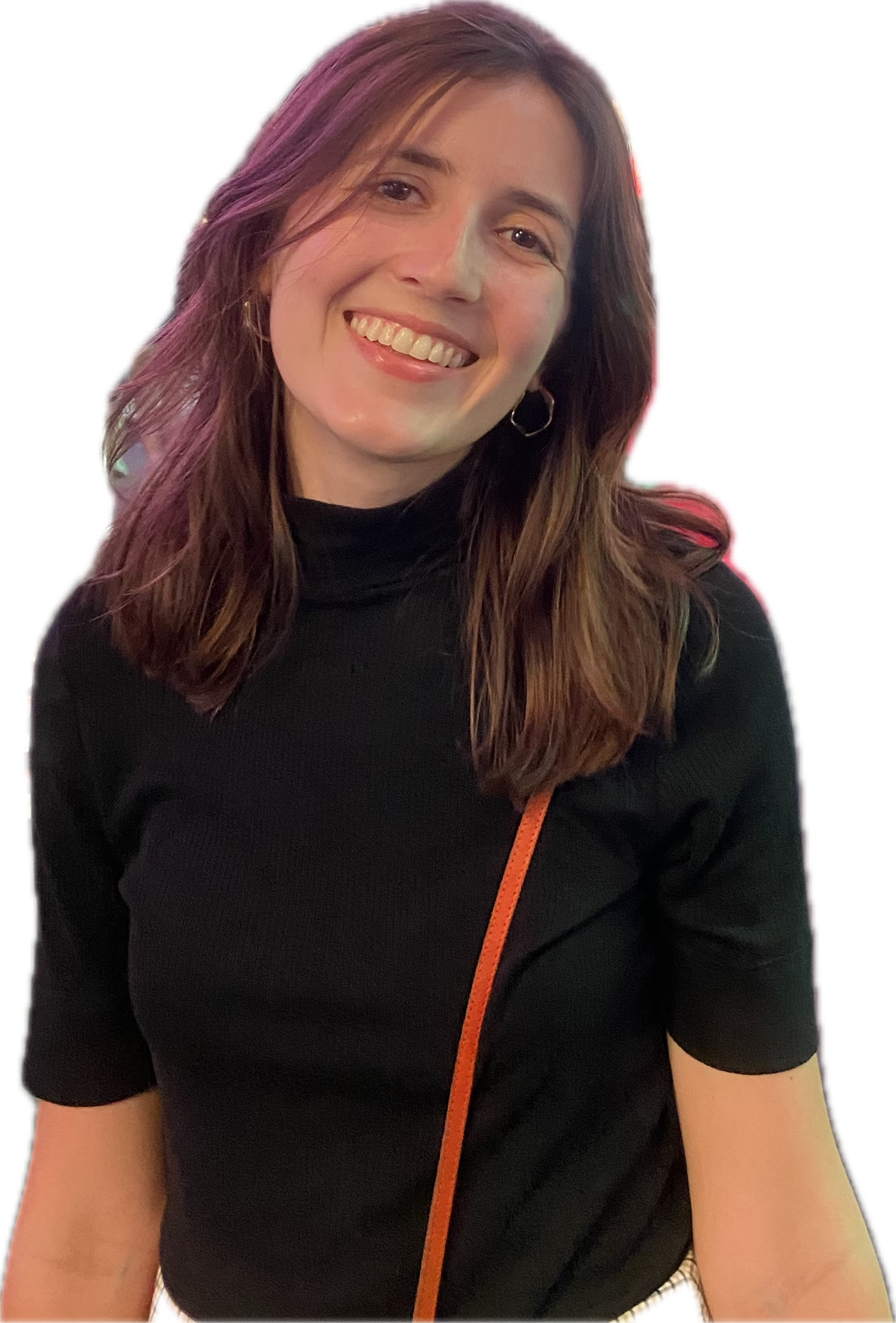 A smiling woman with shoulder-length brown hair with purple highlights, wearing a black top and hoop earrings, with an orange strap visible across her chest.