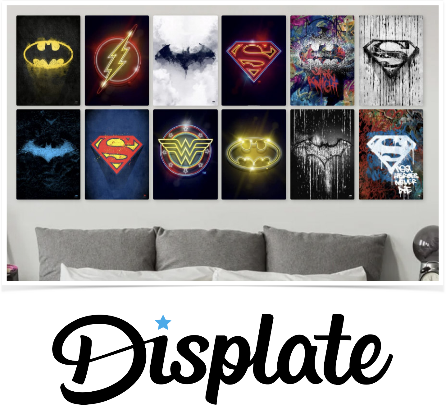 A wall art display featuring twelve superhero-themed posters arranged in two rows. The posters include symbols of Batman, Flash, Batgirl, Superman, Wonder Woman, and others, with various artistic styles. Below the posters, a gray bed with white pillows and a bedside table are visible. The image also has the Displate logo at the bottom.