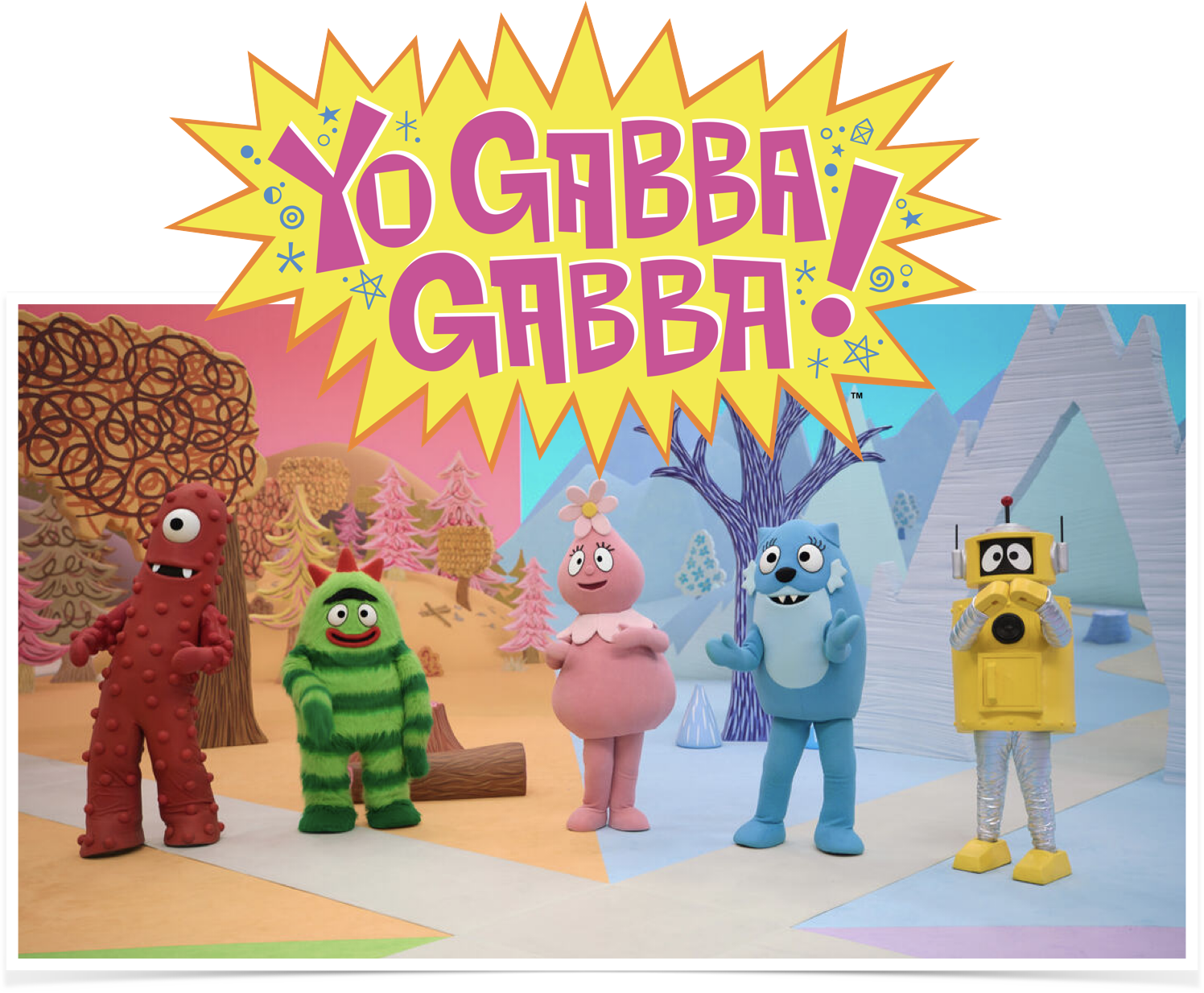 Colorful scene from the animated children's series 'Yo Gabba Gabba!' featuring five character costumes: a red monster with round body and sprouting bumps, a green striped creature with red horns, a pink character with a flower on its head, a blue furry character with a big smile, and a yellow robot with black eyes, set against a whimsical background of trees and mountains.