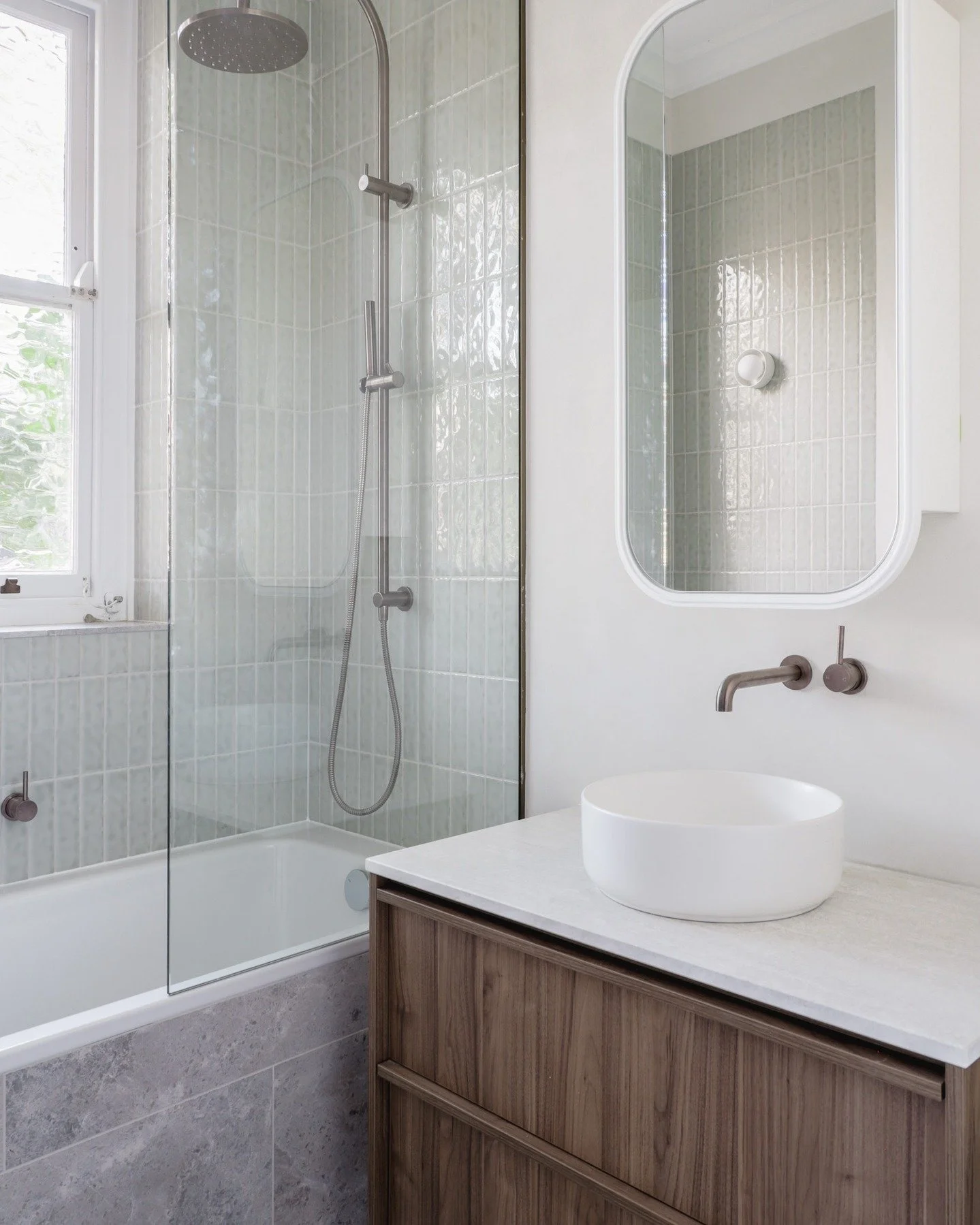 This bathroom came together early.
We worked through the layout, joinery and finishes before the build started, which made everything else easier.

The sage green tiles, microcement and walnut cabinets were chosen to sit comfortably within the origin