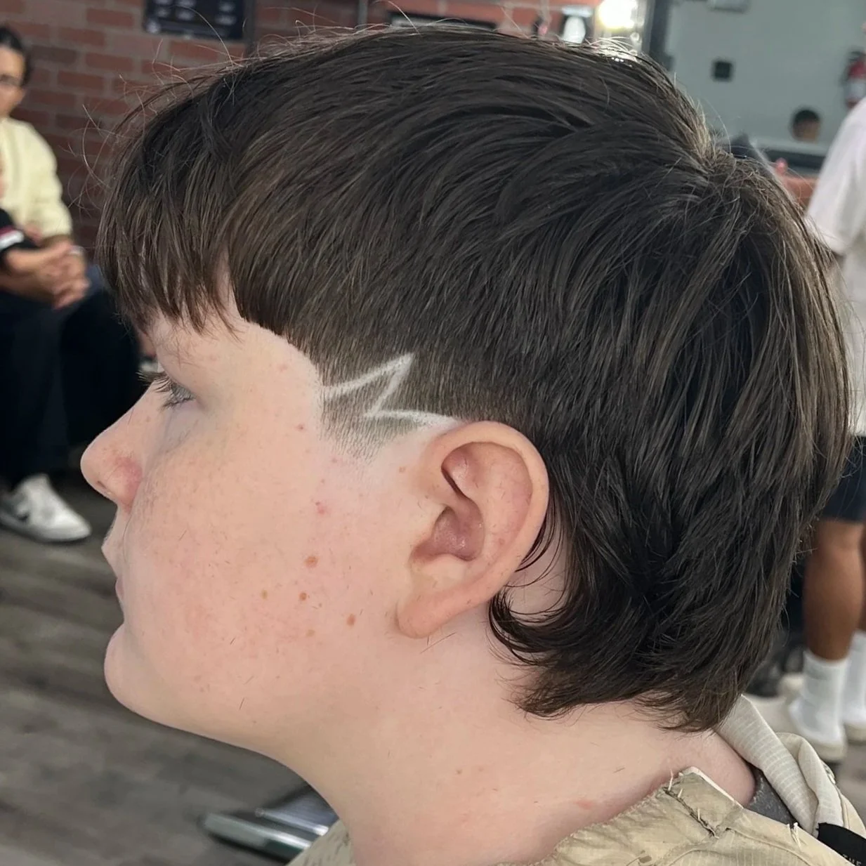 Clean taper fade with a design by Nate the Barber in Orange County