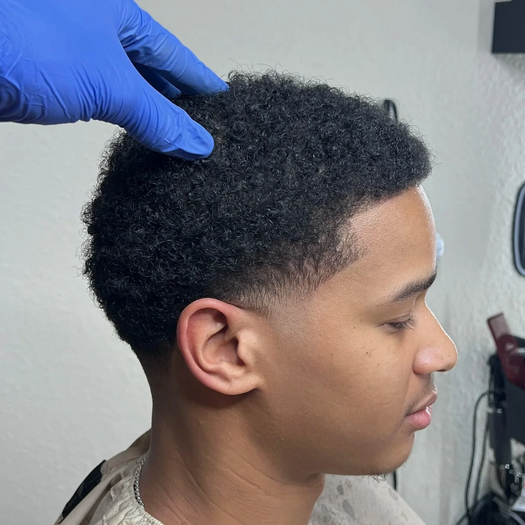 Fade haircut on curly hair done by CutByNate in Orange County