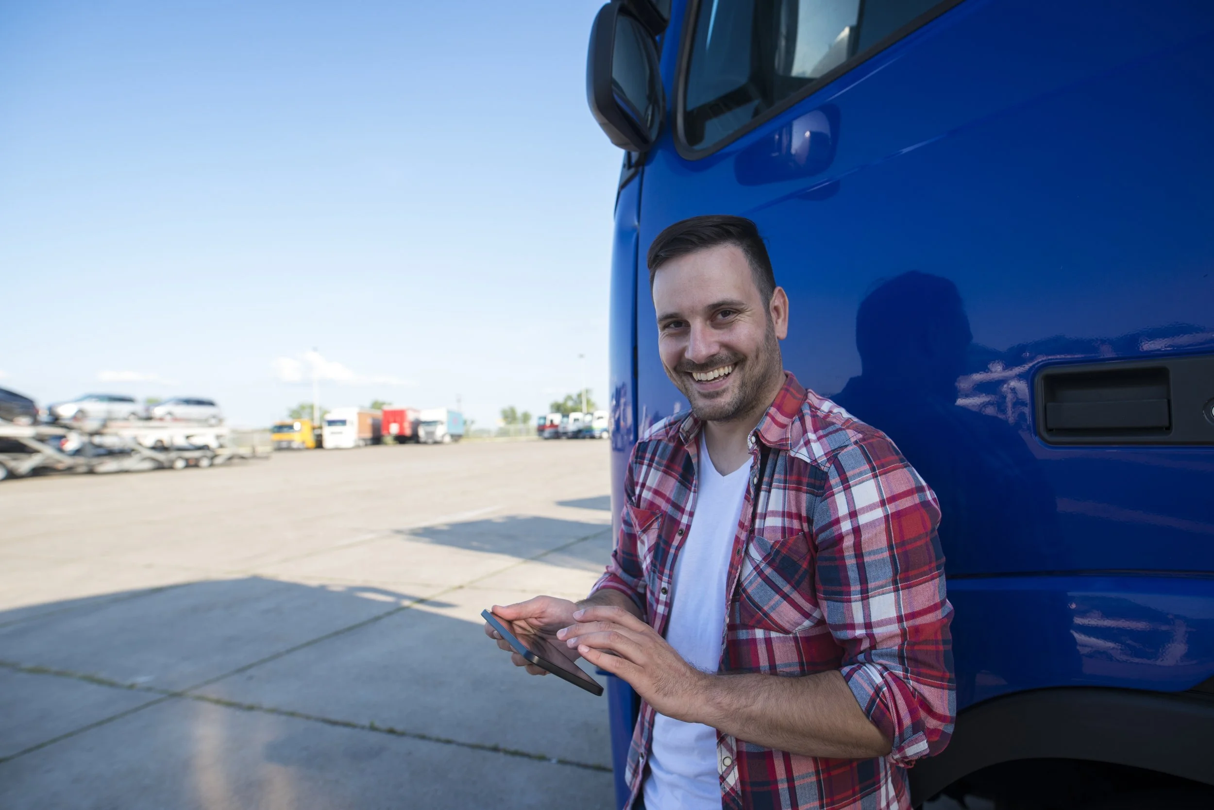 shot-professional-truck-driver-standing-by-his-truck-with-tablet-setting-up-gps-navigation-ride.jpg