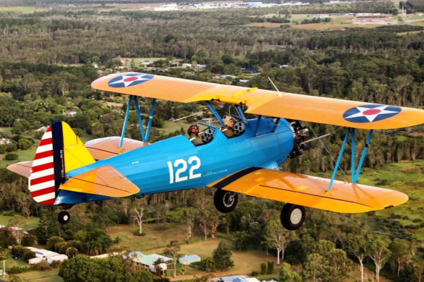 blue and yellow boeing-stearman-vh-snm aircraft