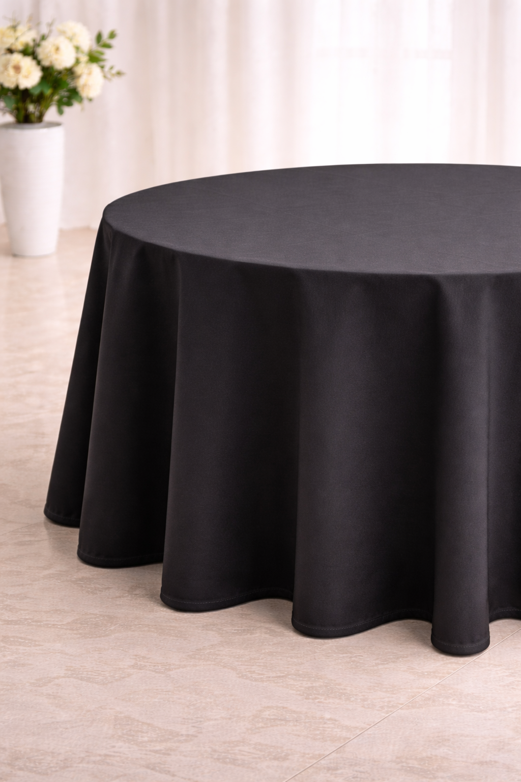 Elegant black tablecloth in soft light.png