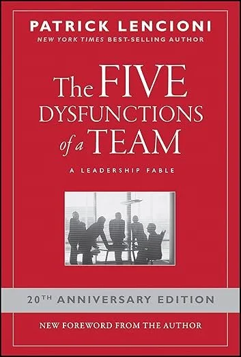 Cover of the book titled "The Five Dysfunctions of a Team" by Patrick Lencioni, 20th anniversary edition, with a red background and a black-and-white silhouette of a business team in a conference room.