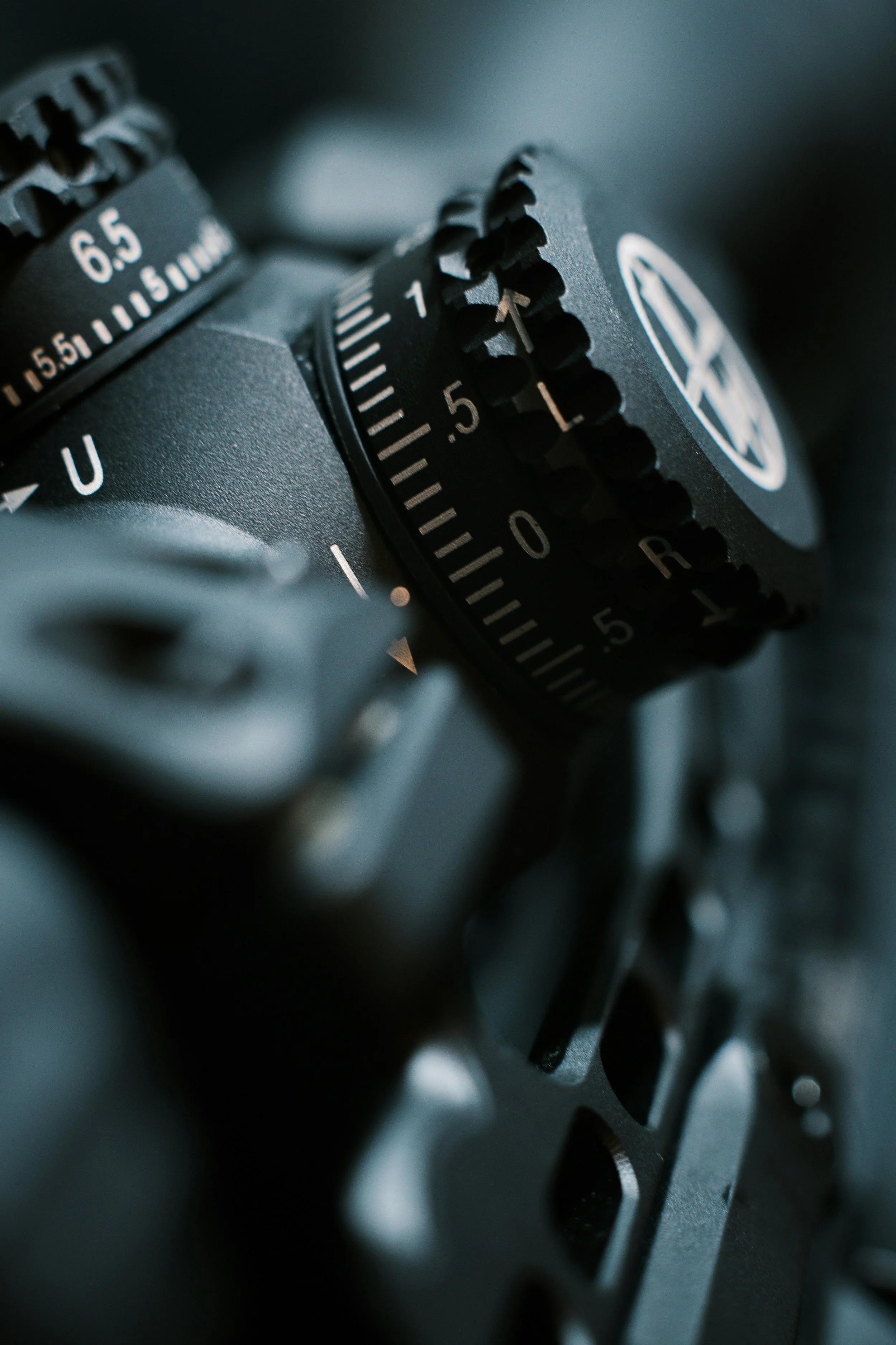 Close-up of a camera's control dials, showing focus and mode settings.