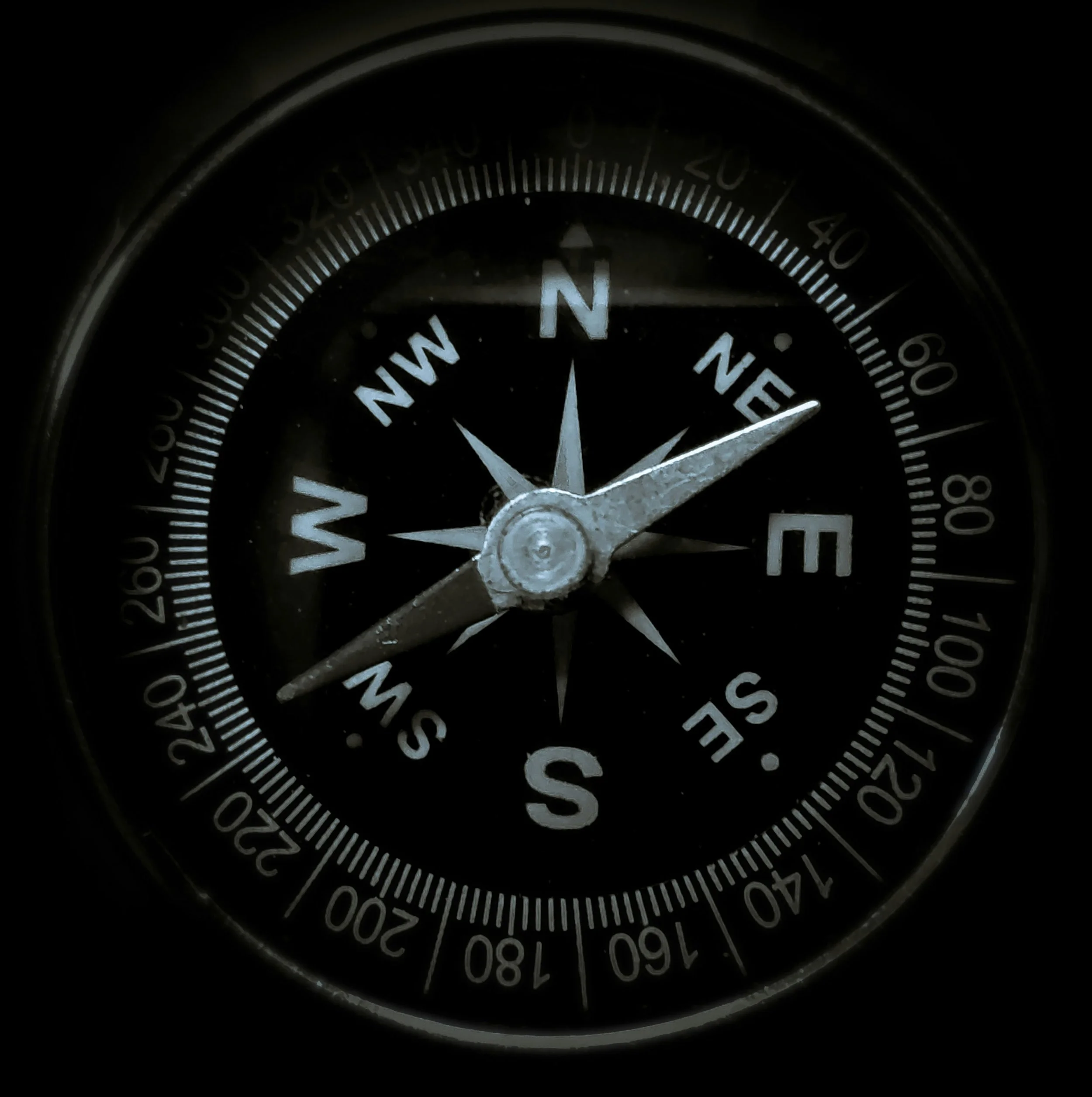 A compass showing North at the top, with the needle pointing slightly to the east of north, on a black background.