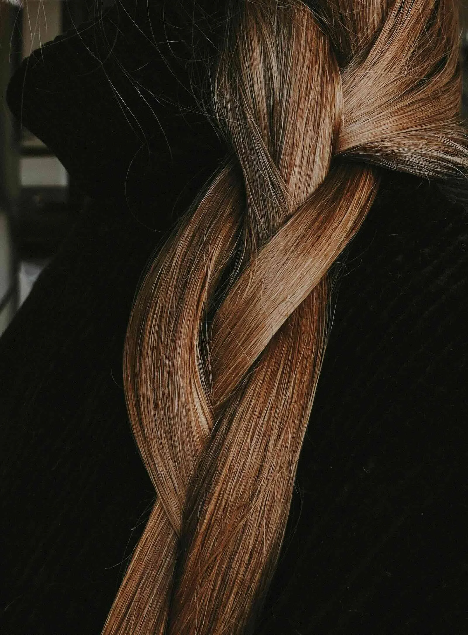 Smooth brunette hair with subtle dimension woven into a braid showing consistent tone and long-lasting hair color
