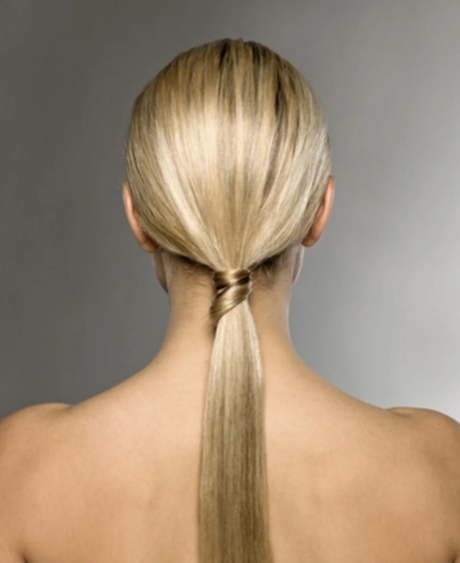 Beige blonde hair with soft low-contrast dimension in a sleek ponytail, modern spring hair color NYC by AlbertColor