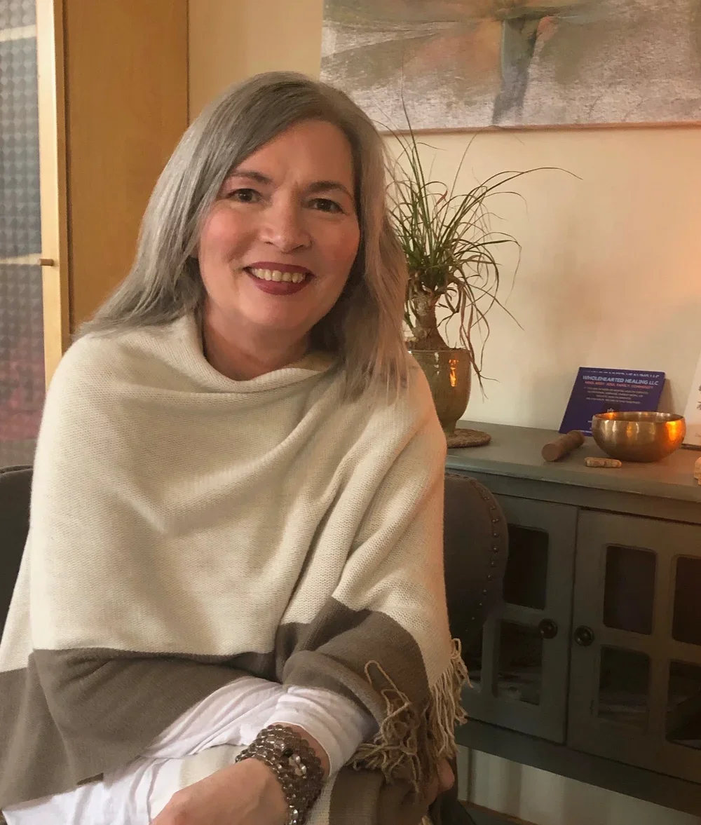 Sherry L. Strand, Usui Reiki master and holistic health practitioner at Resourced & Resilient, smiling in a peaceful wellness setting. Click here for Sherry Strand's bio.