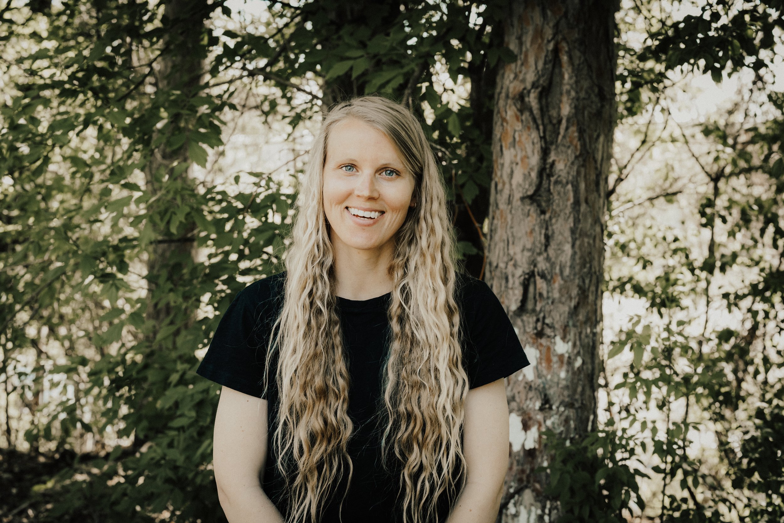 Jenni Burg, registered dietitian at Resourced & Resilient, smiling and holding a cup of ice cream. Click here for Jenni Burg's bio.
