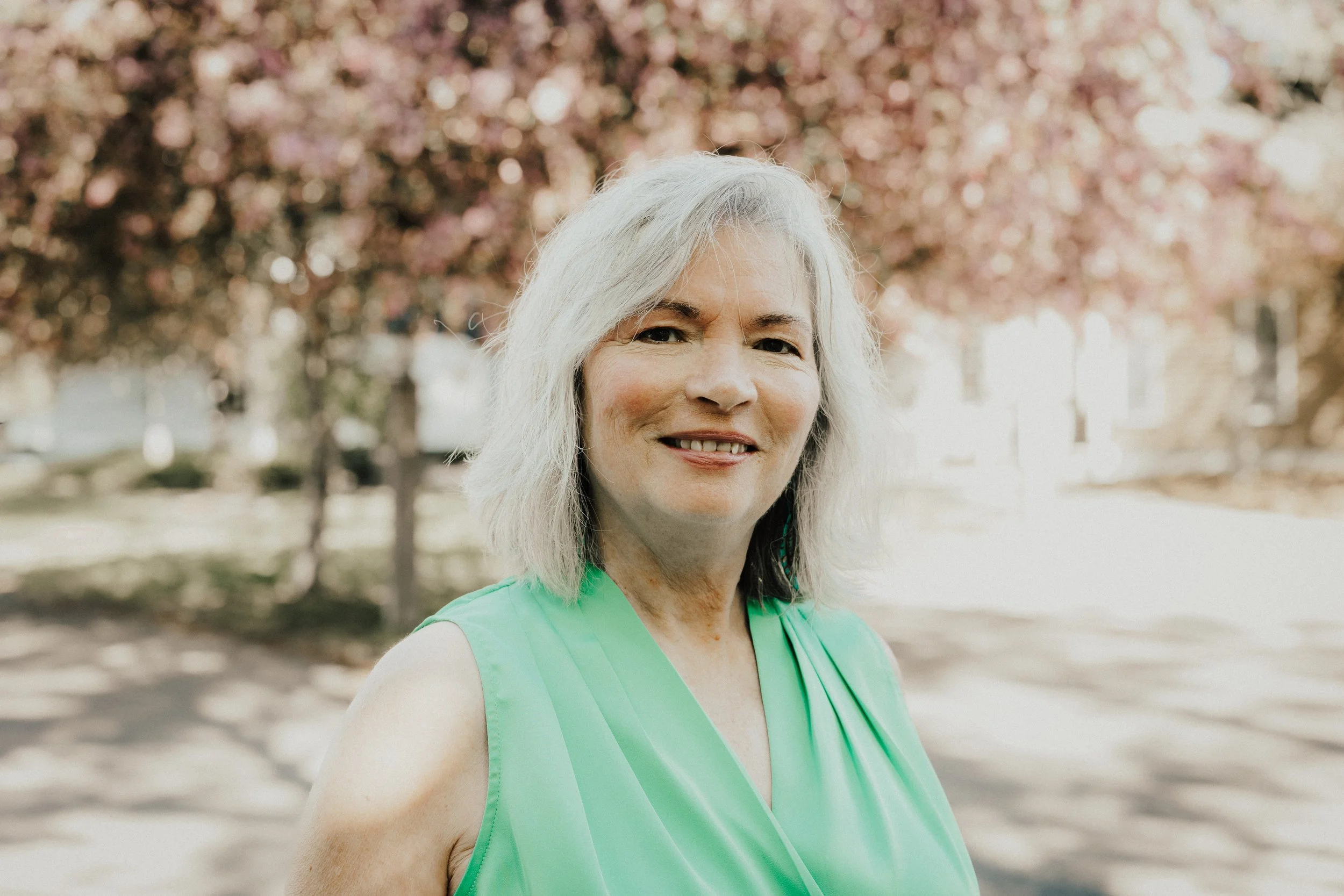 Sherry L. Strand, Usui Reiki master and holistic health practitioner at Resourced & Resilient, smiling in a peaceful wellness setting. Click here for Sherry Strand's bio.