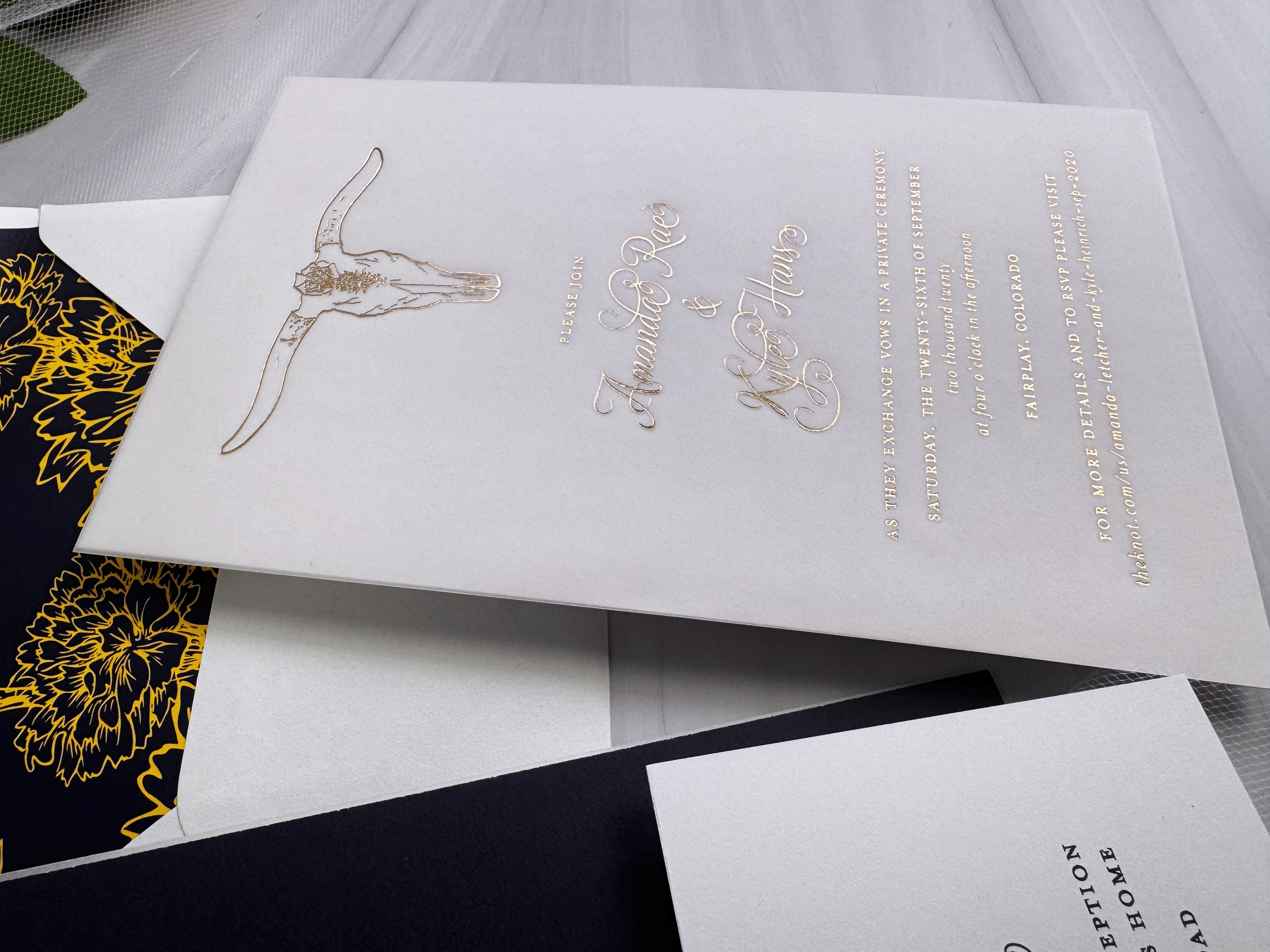 Invitation or announcement card with intricate gold design. The card features elegant, gold, cursive script with some details in smaller gold print. The main text invites guests to a private exchange vows ceremony on a specific date and location.