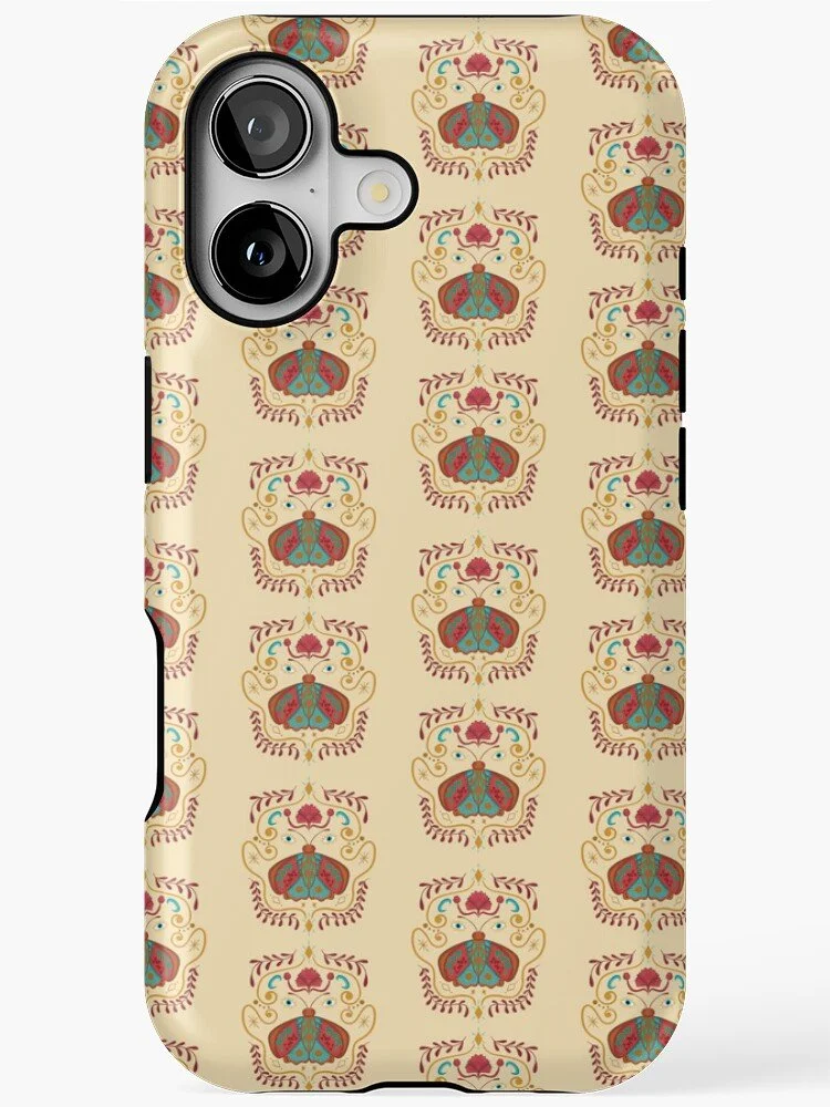 Phone case with a pattern of symmetrical insect-like designs in red, blue, and gold on a cream background.