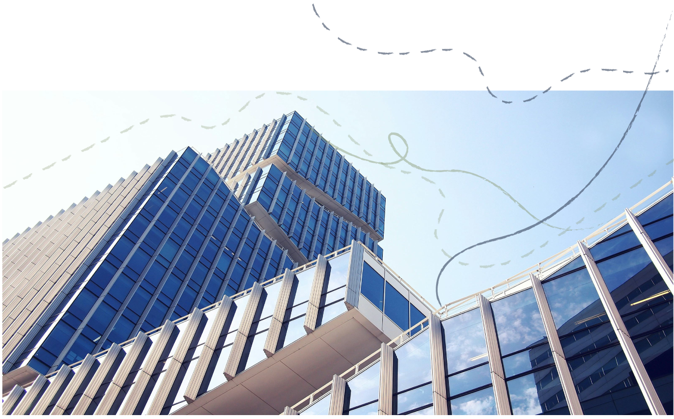 Low-angle view of modern glass skyscraper buildings under a light blue sky with faint, whimsical lines connecting points in the sky.