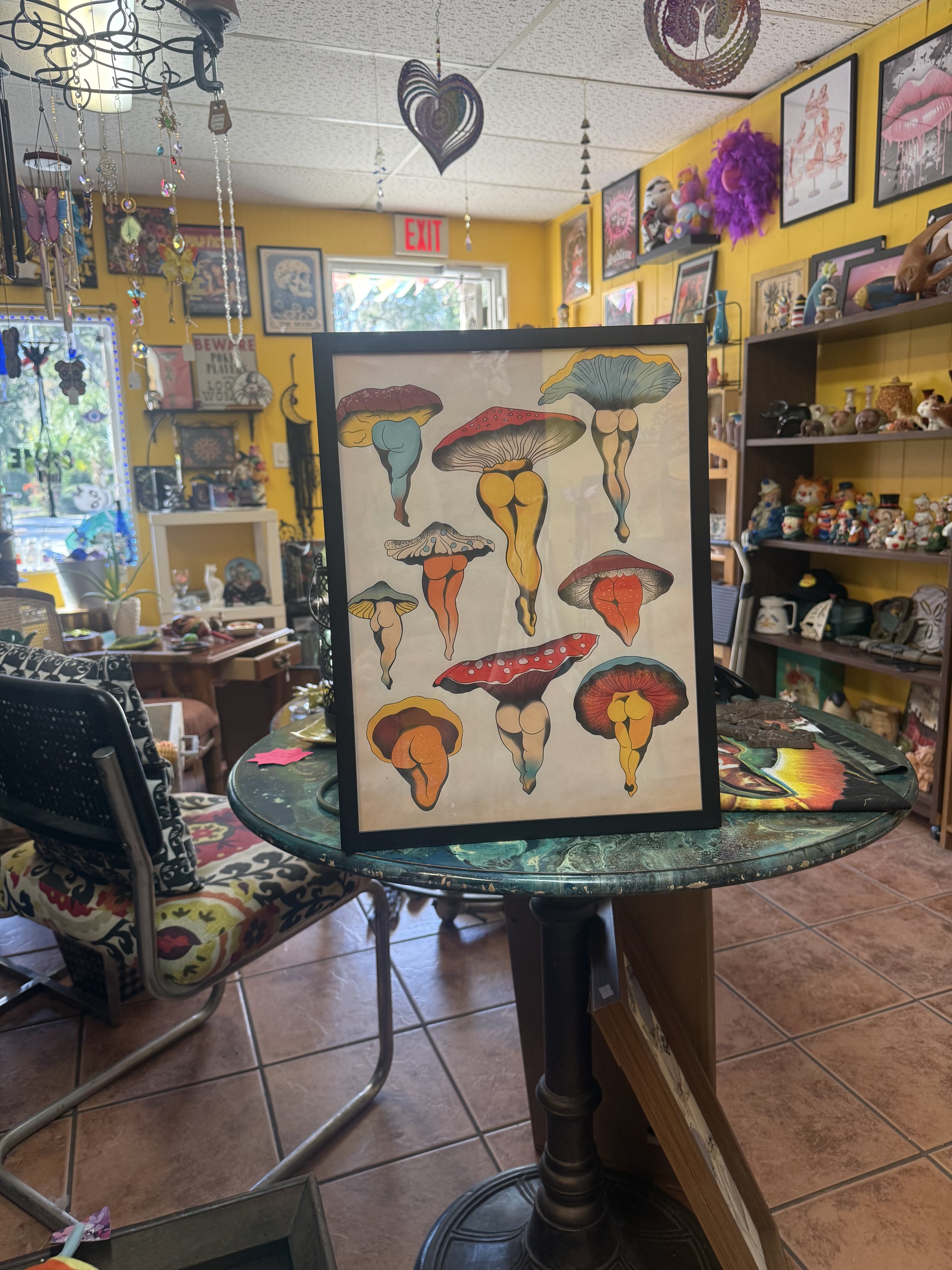 Framed vintage mushroom illustration displayed inside Bobeana’s Bazaar, a creative local maker shop in downtown New Port Richey, Florida.