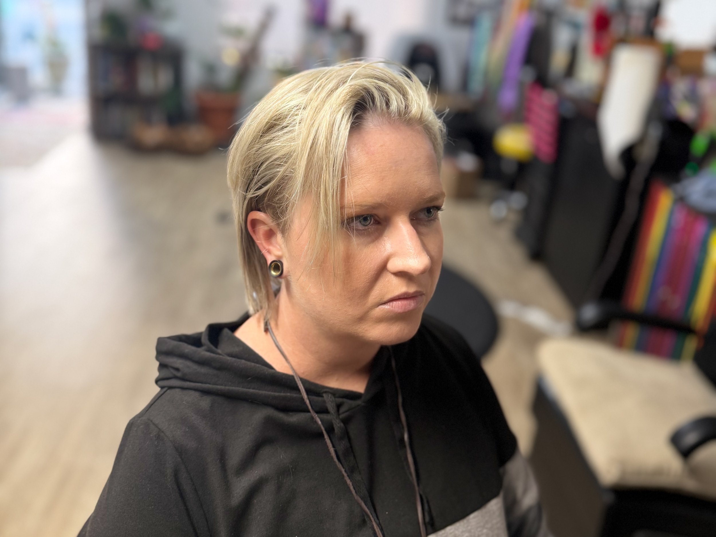 Gender neutral short haircut with undercut and textured top at inclusive New Port Richey hair salon