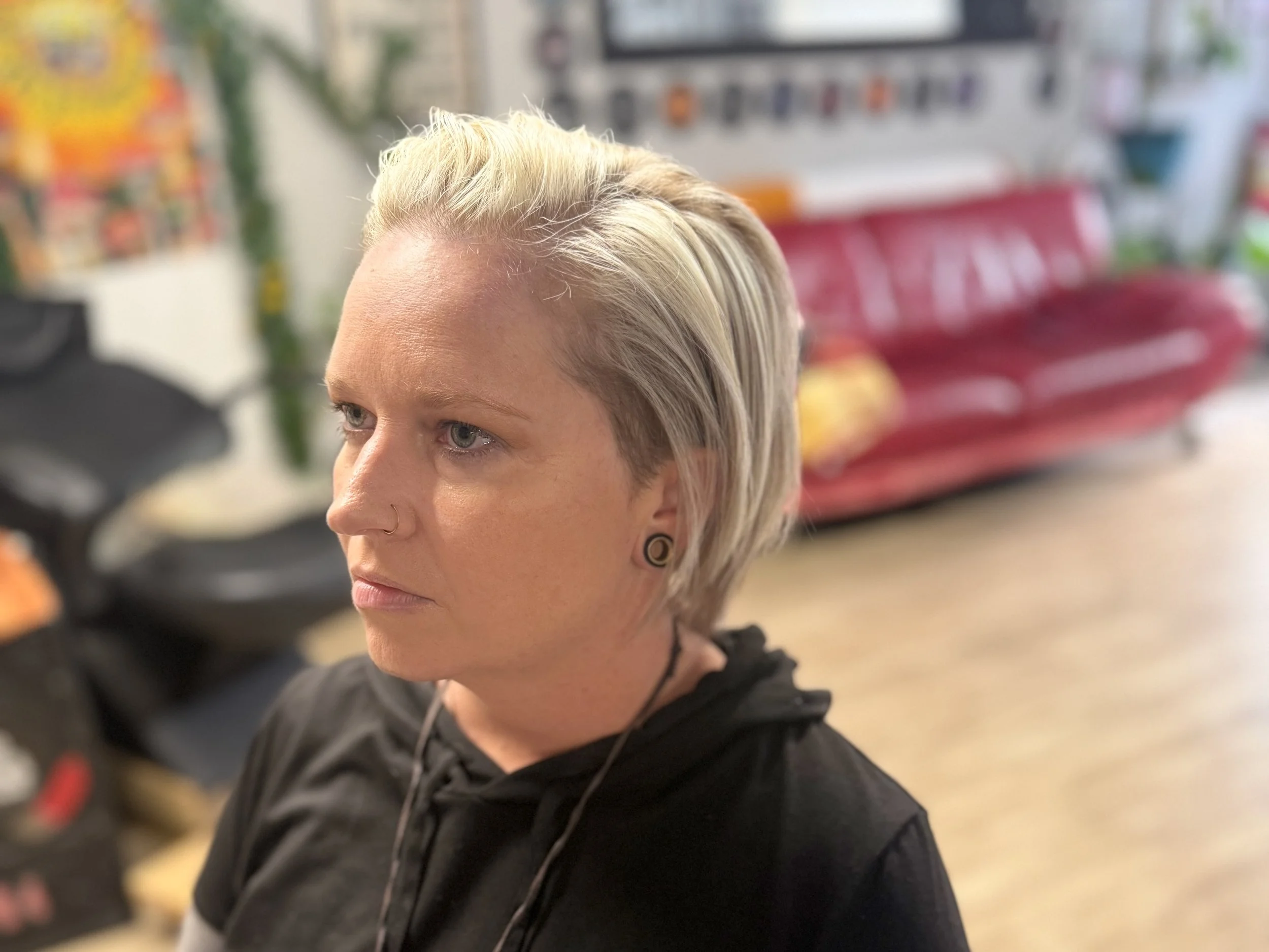 Side view of gender neutral short haircut with soft taper at inclusive New Port Richey hair salon