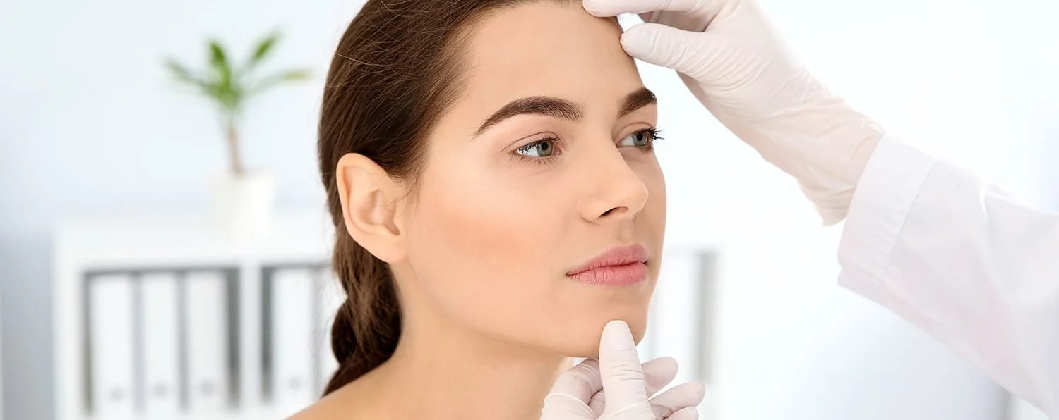 Licensed esthetician in Wheaton IL performing a professional skin consultation to assess facial health and recommend personalized skincare treatments.