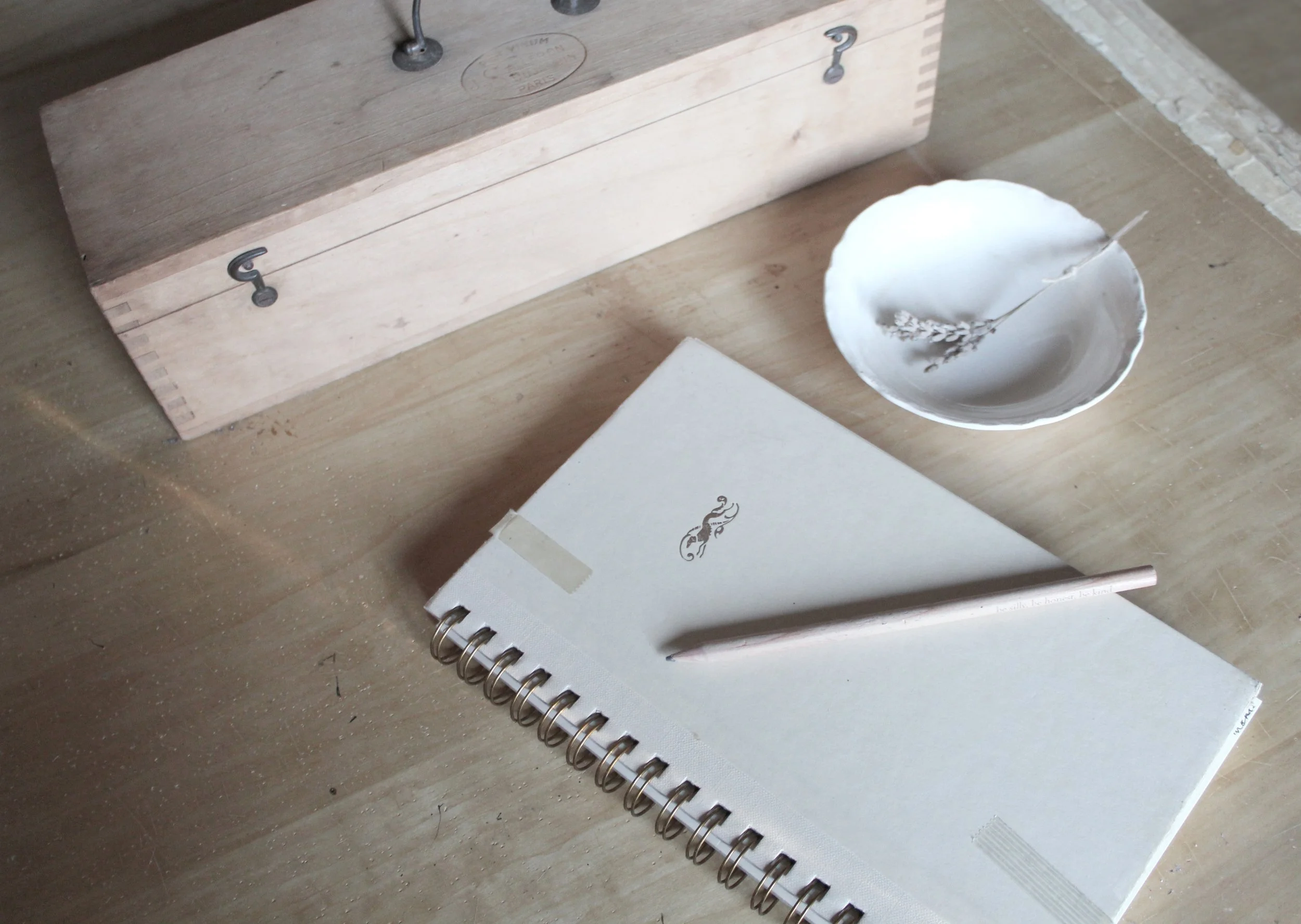 image of journal with pencil and wooden box on table