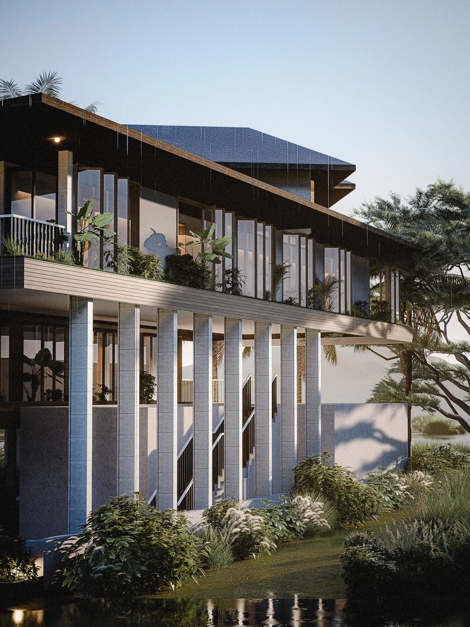 Modern multi-story building with large glass windows, surrounded by greenery and trees, during daytime.