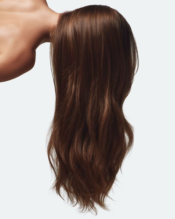 A brown mannequin head with long, wavy hair