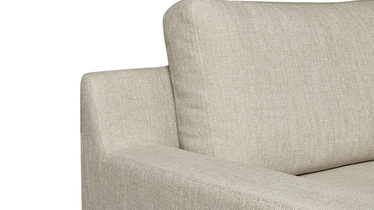 Canapé beige avec coussin rembourré vue partielle