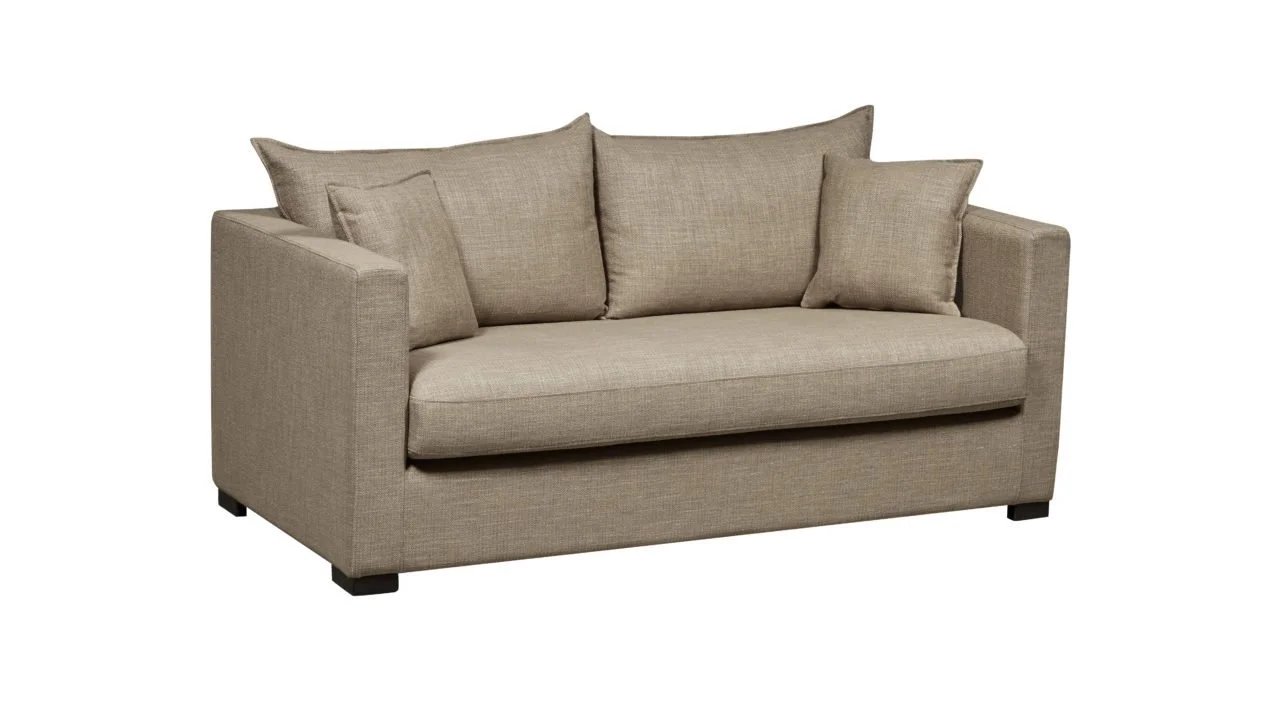 Canapé beige avec trois coussins, en tissu, sur un fond blanc.