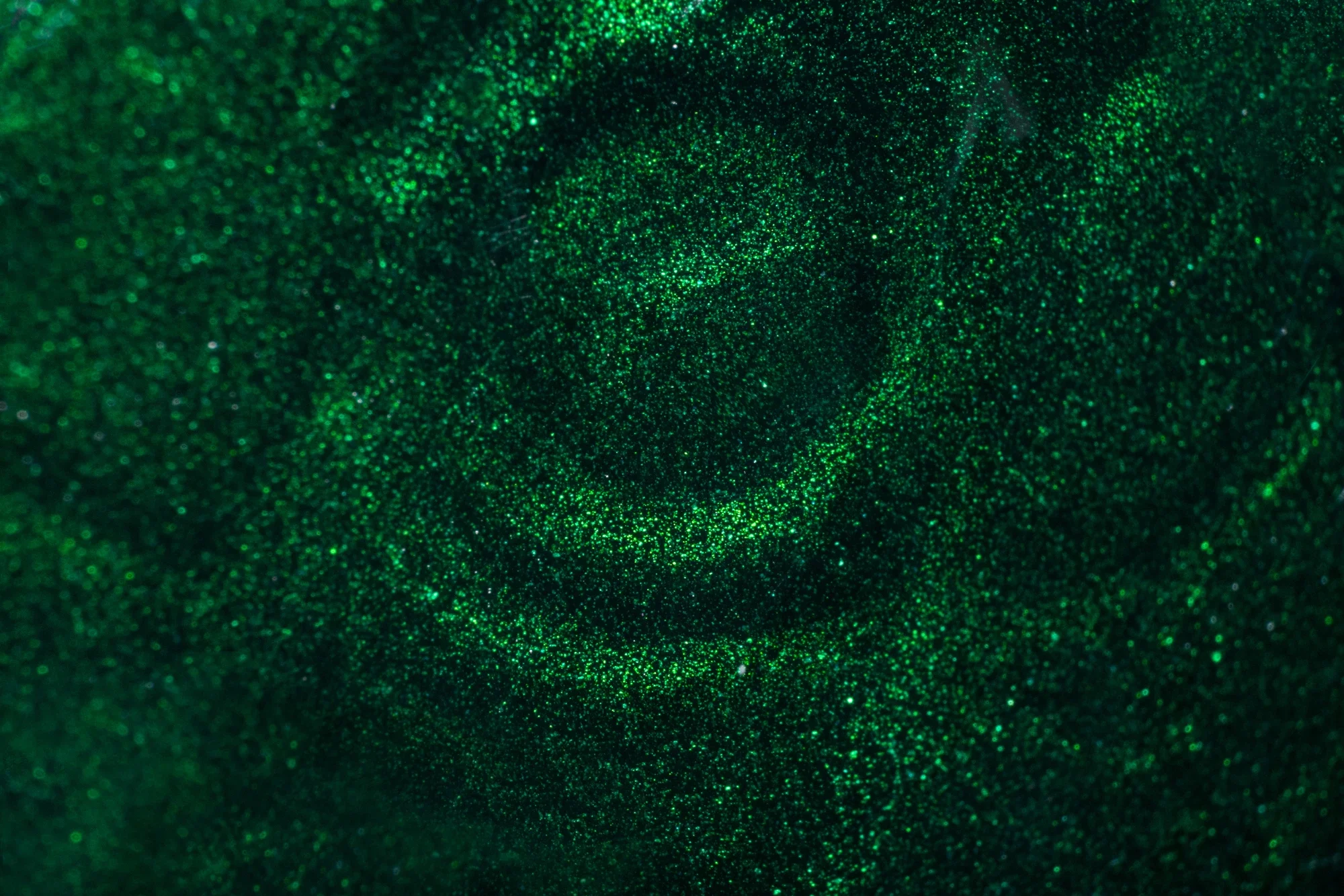 Surface verte scintillante avec un effet de vortex au centre
