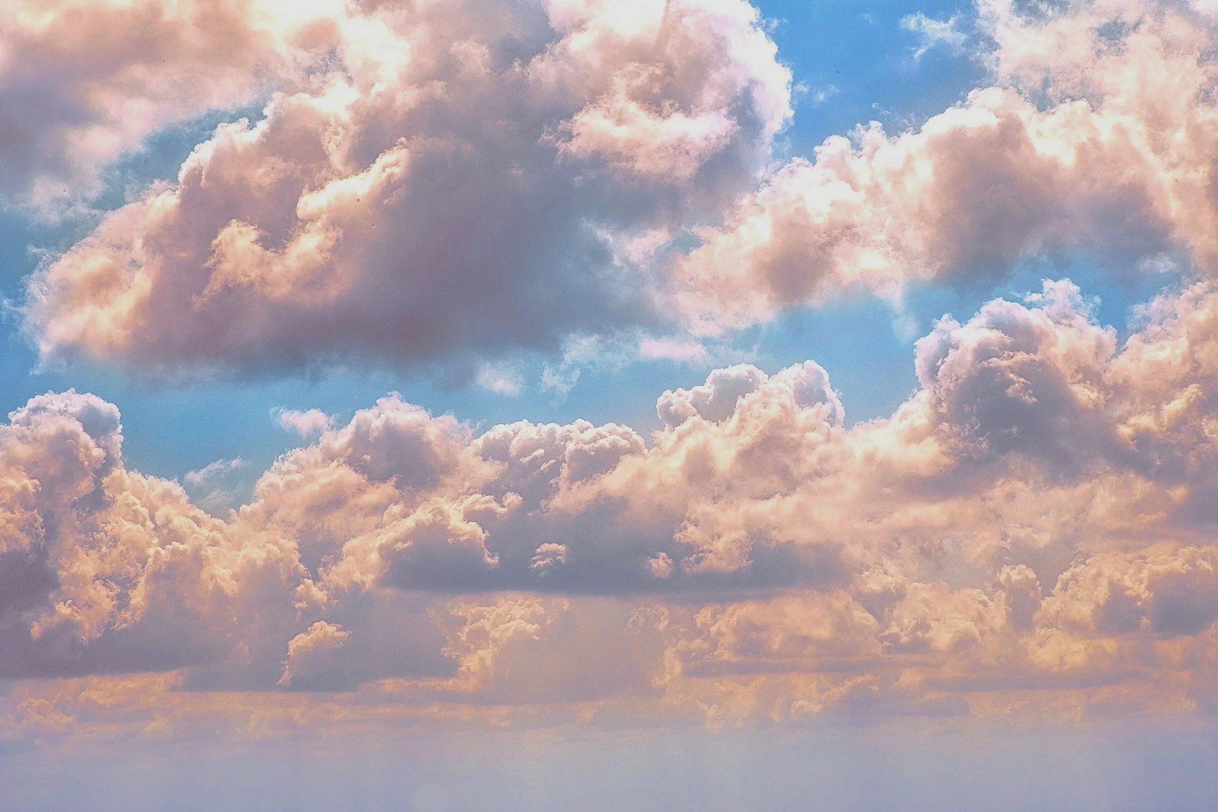 Colorful sky with pink and blue clouds.