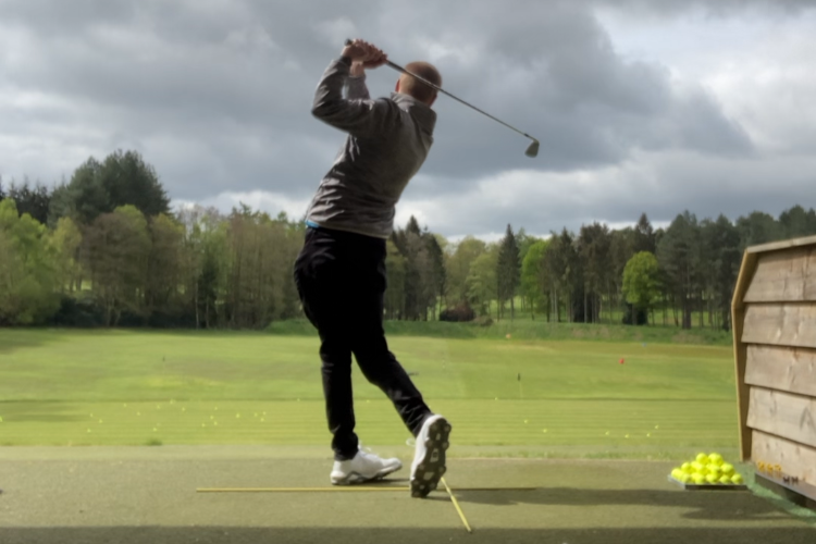 Ali Hall practicing on the range at Bearwood Lakes prior to playing a round.