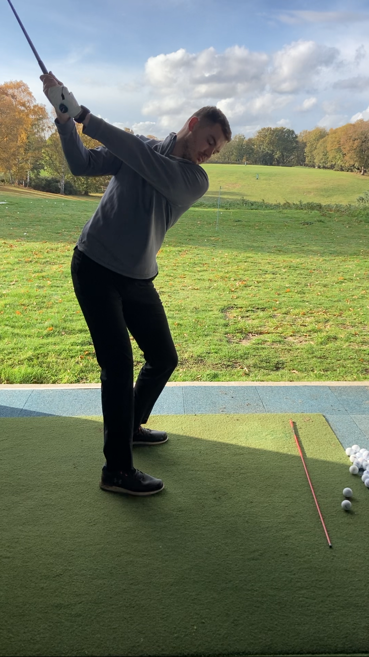 A golf lesson taking place in the swing studio at Woodbridge Golf Club in Suffolk