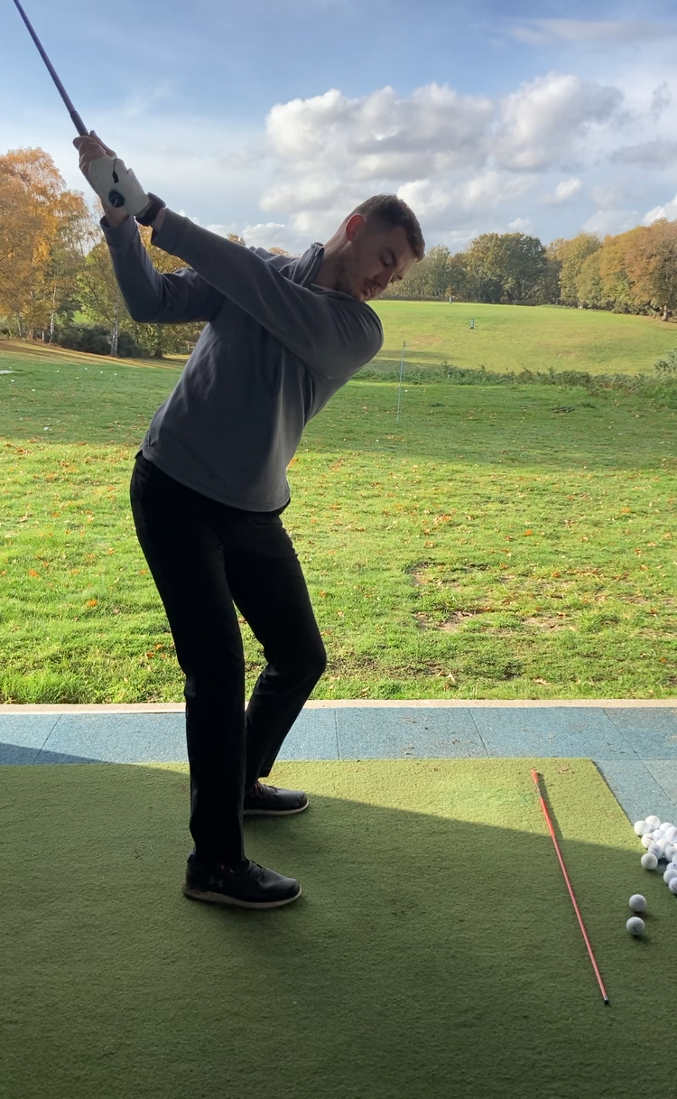 Professional golf lesson taking place in the swing studio at Woodbridge Golf Club, Suffolk.