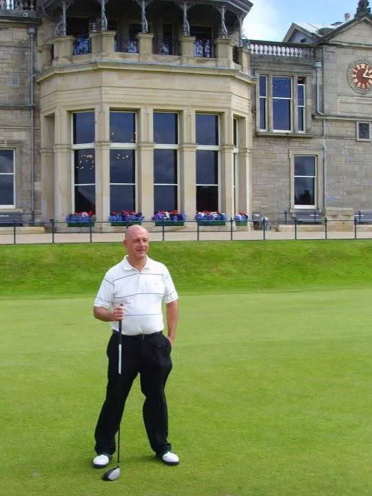 Photo of a coaching client after playing a round at the St Andrews Old Course.