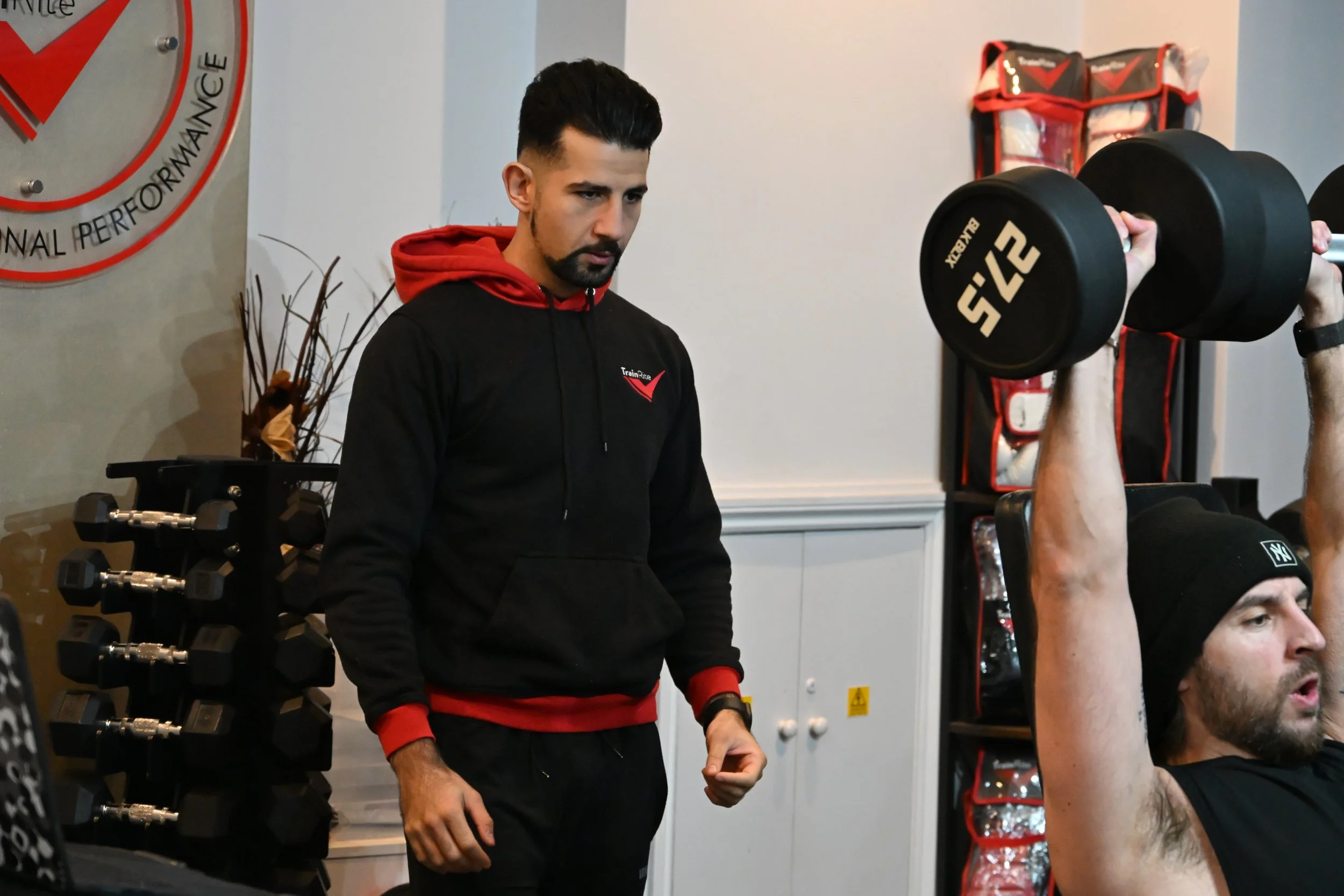 Personal trainer, Joseph training a client.