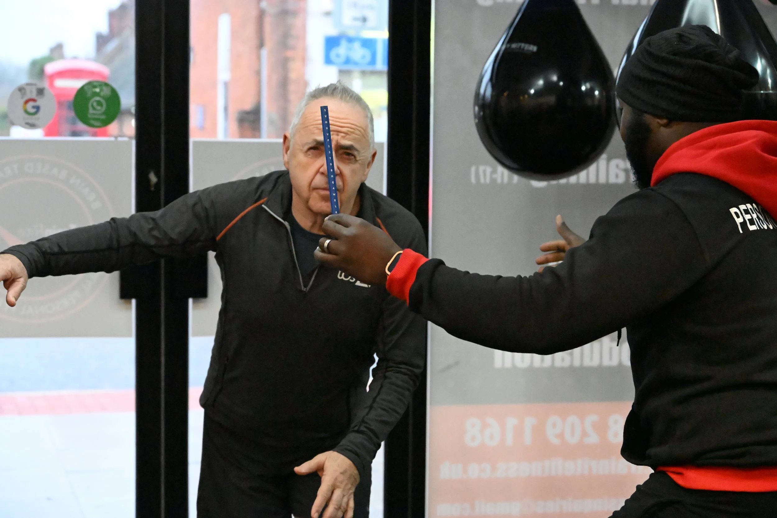 TrainRite founder, Emmanuel, training a client in a gym.