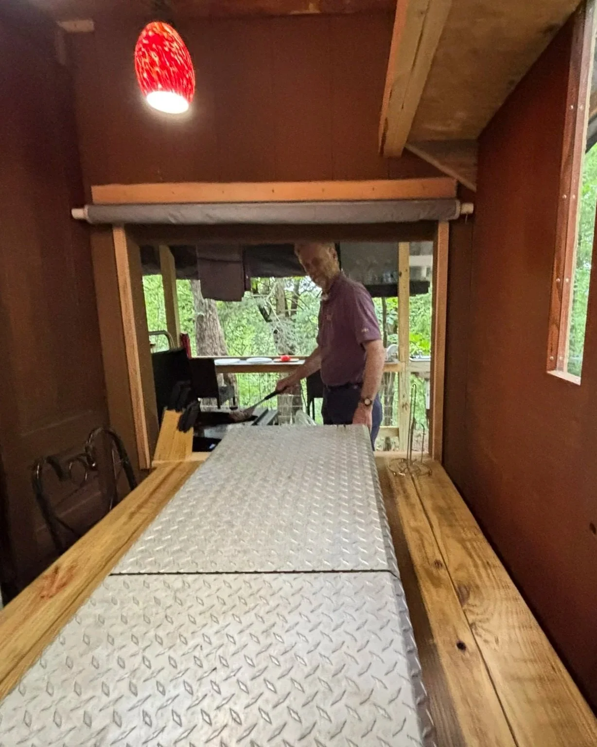 Pass through window from back deck cooking station to interior dining table