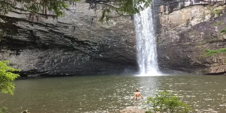 A 15 minute drive away. Easy access from the parking lot. Nice swimming below the falls. We always recommend this one if you do no others.