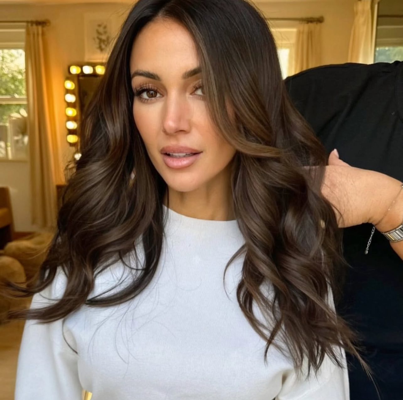 Michelle Keegan hair colour and hair style. Long, wavy brown hair, styled with loose curls.