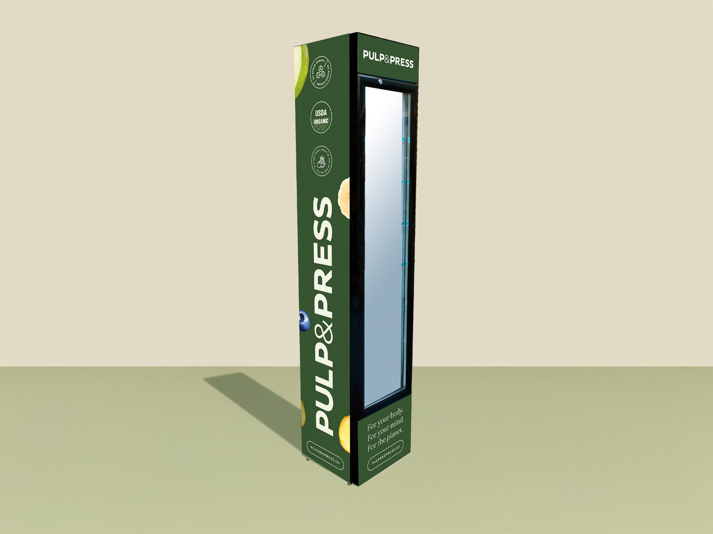 A green Pulp & Press vending machine with a glass front, promoting organic juice and healthy lifestyle, on a beige wall background.