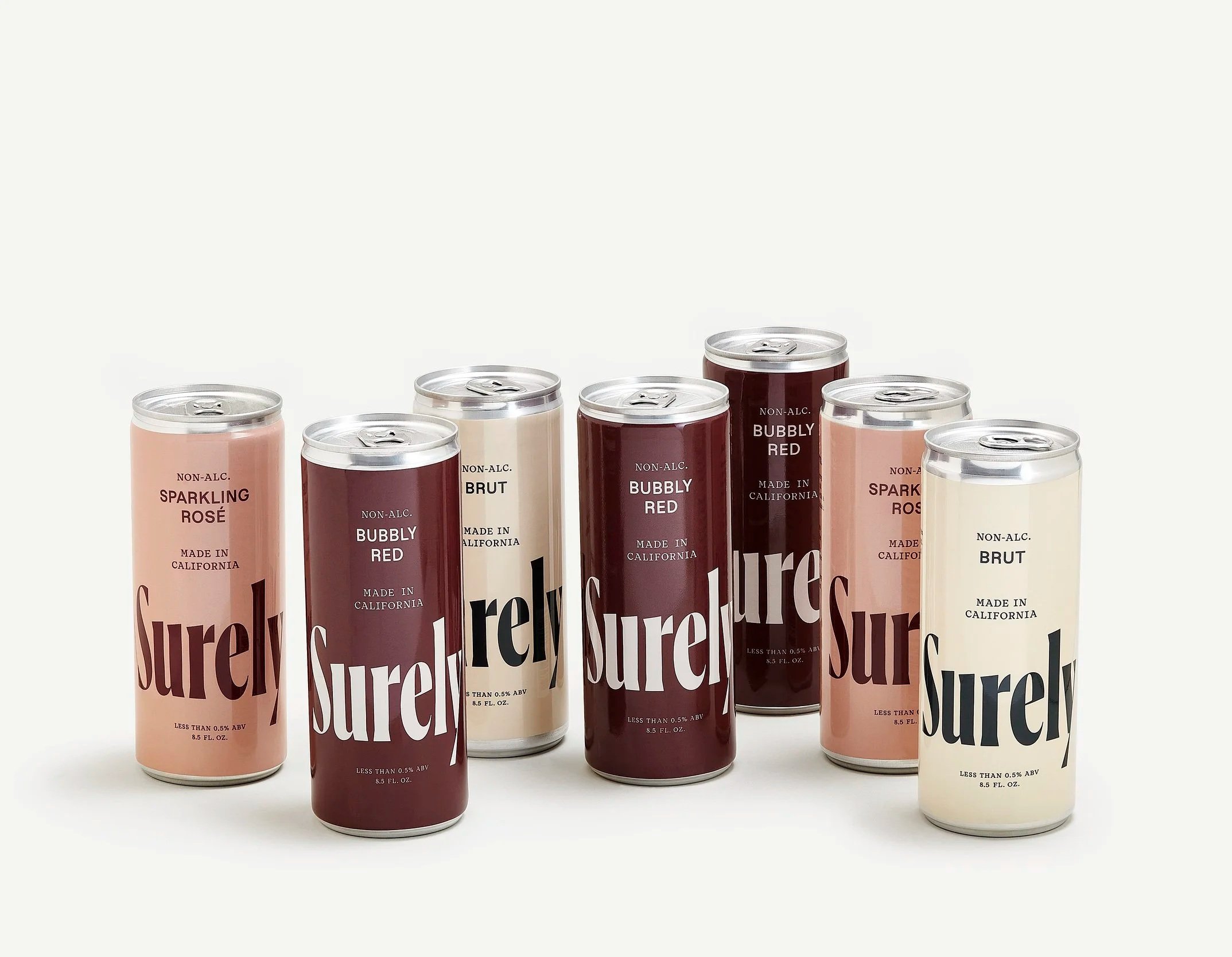Six cans of flavored sparkling beverages, including rosé, brut, and bubbly red, arranged in a row on a white background.