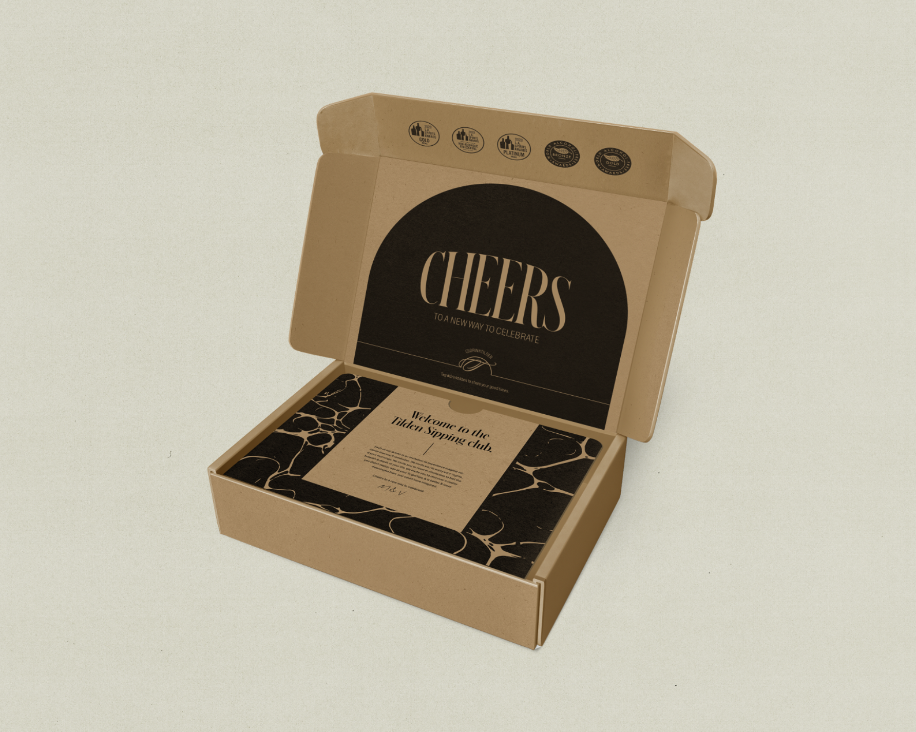 Open cardboard box with black and beige branding, containing a card that reads 'Welcome to the Tent Sipping club' inside.