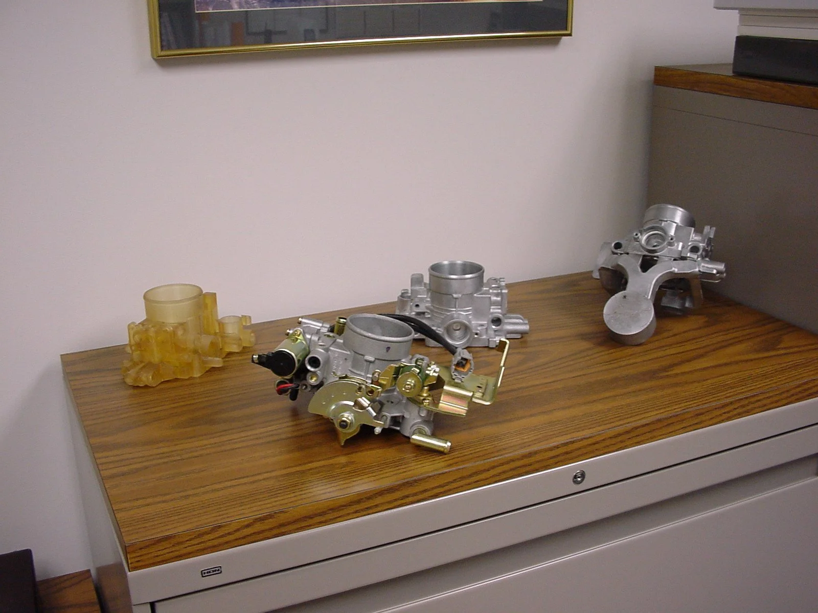 Various engine components laid out on a wooden table.