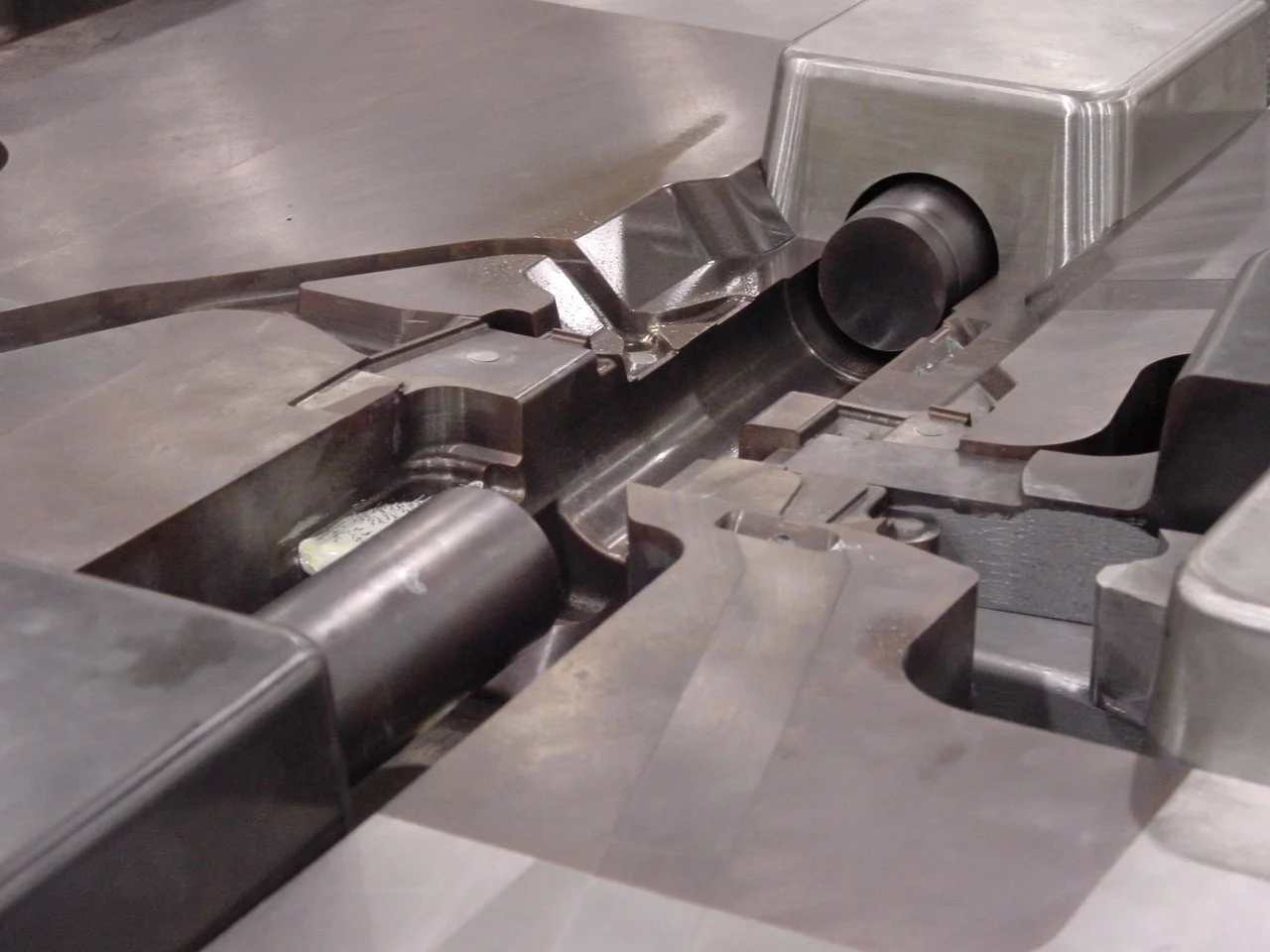 Close-up photo of a metal industrial machine part or mechanical component used in manufacturing.